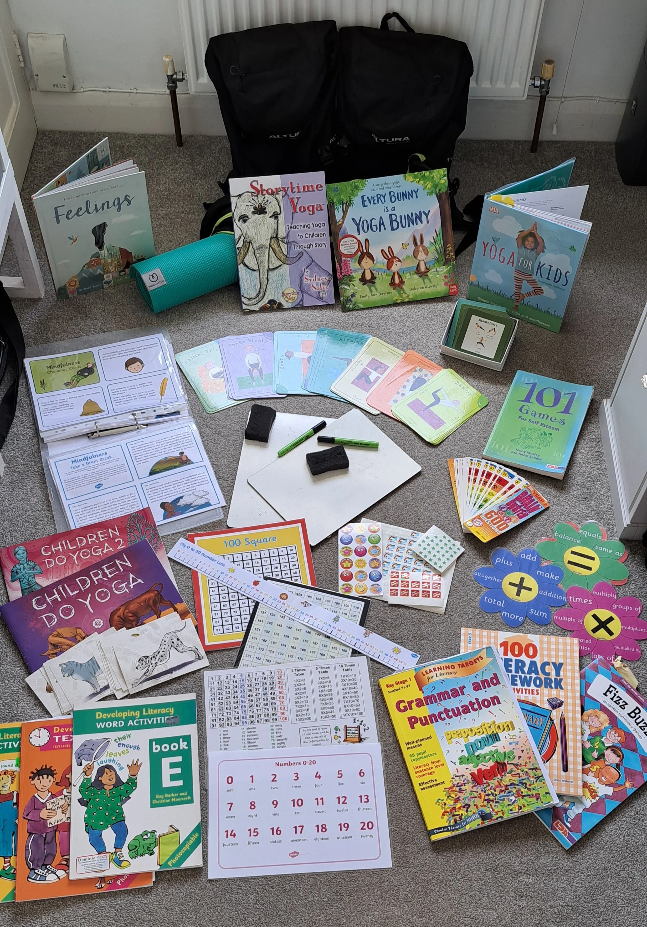 Heather's teaching materials, including yoga books, activity cards and teaching aids.