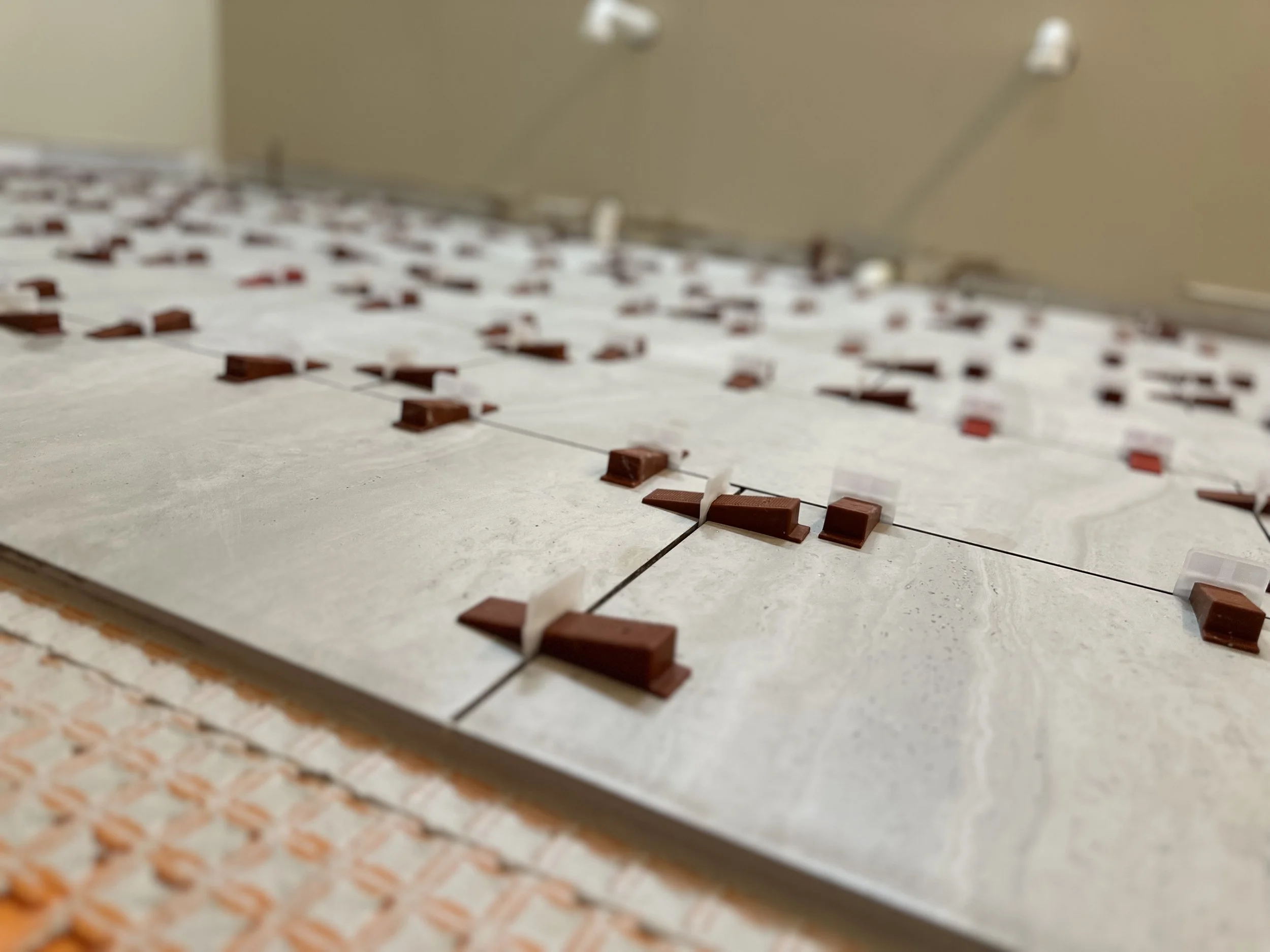 Close-up view of a computer chip with rectangular components on a white surface, with some small transparent plastic pieces attached to the components.