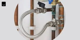Pipe fittings and plumbing connections including a flexible hose connected to copper and metal pipes.