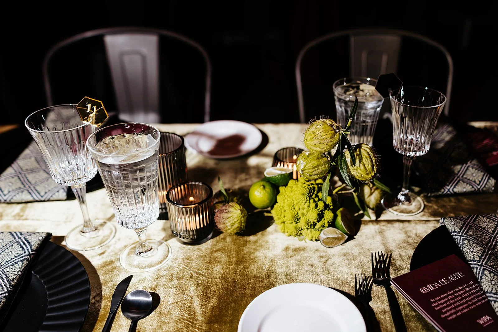 Experiential wedding tablescape design with custom signage and draping by Bella Mystique in Minneapolis