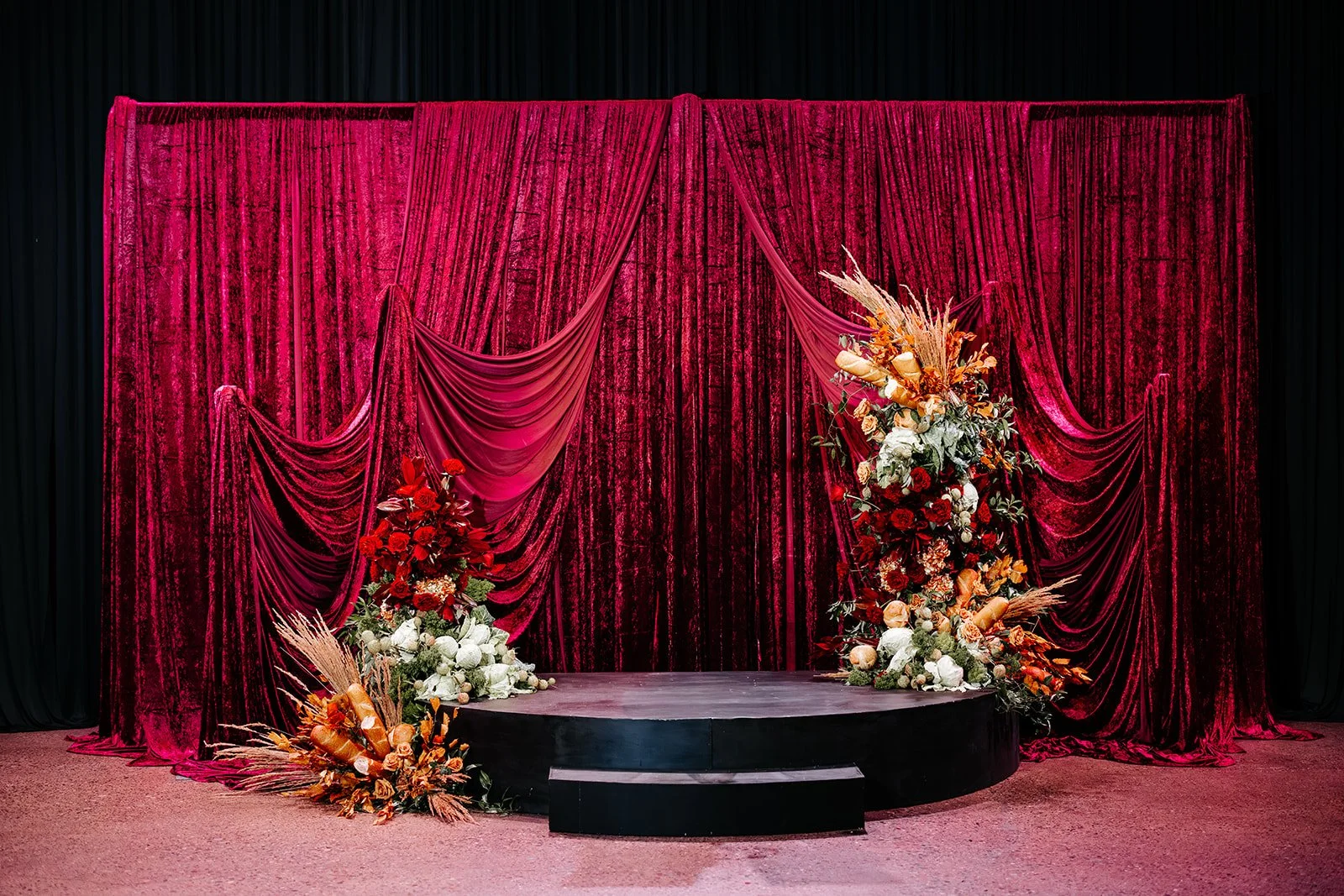 Immersive event installation with velvet draping and floral design by Bella Mystique