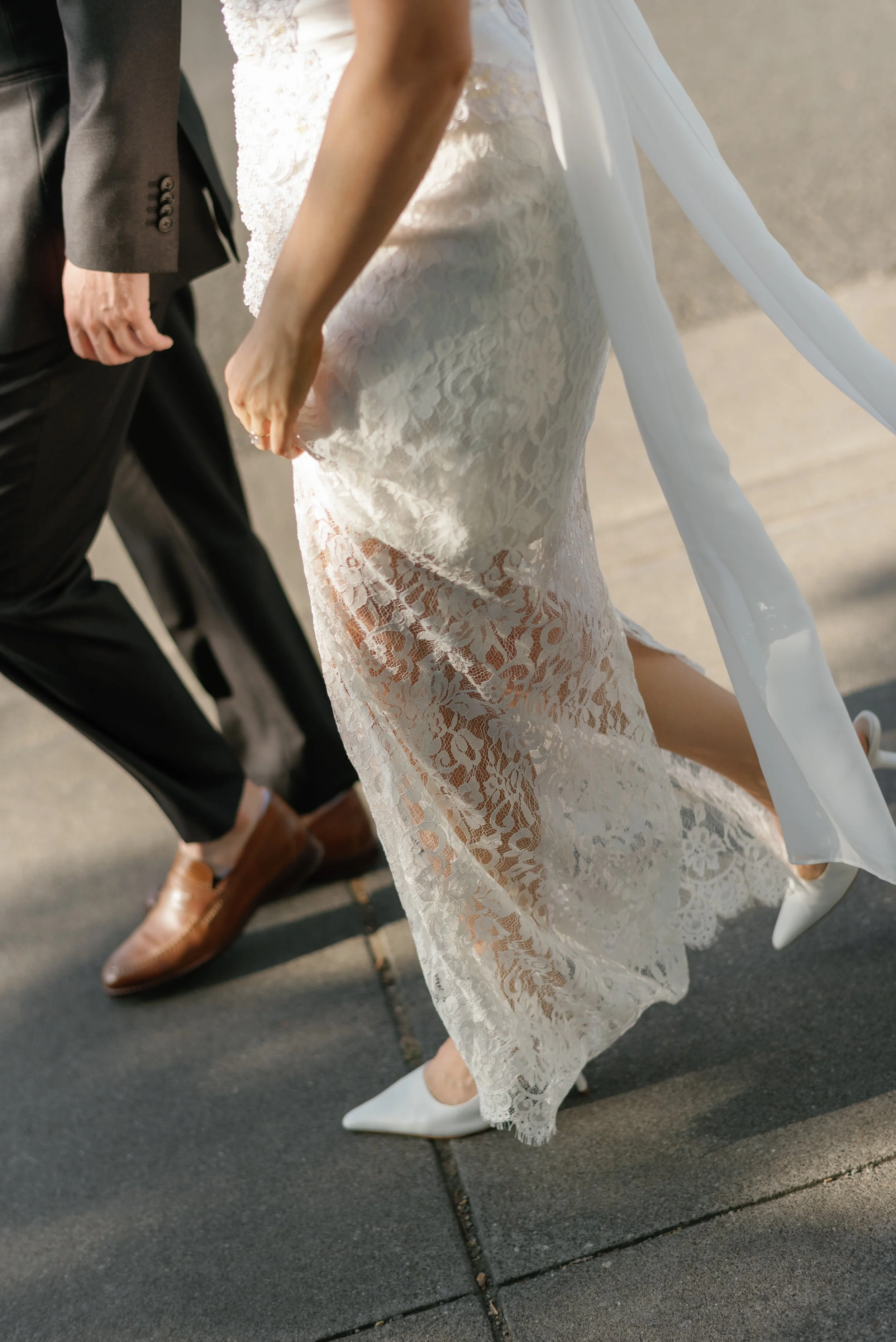 Mannequin torso in front of a window with plants on windowsill in a room with white walls and radiator.