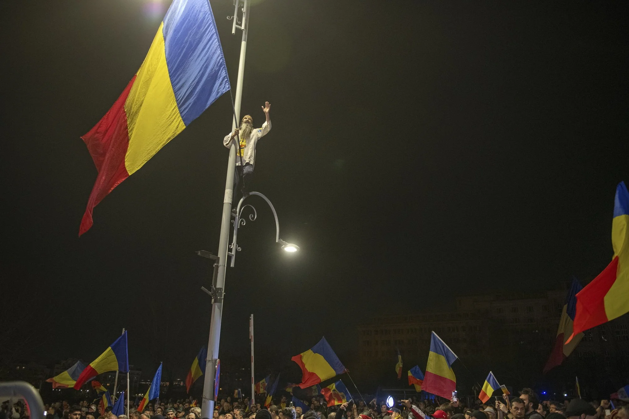 The "Dacian Flag Men", Cezar Avramuta, is waving a national flag during mass demonstration showing support to ultranationalist leader Calin Georgescu