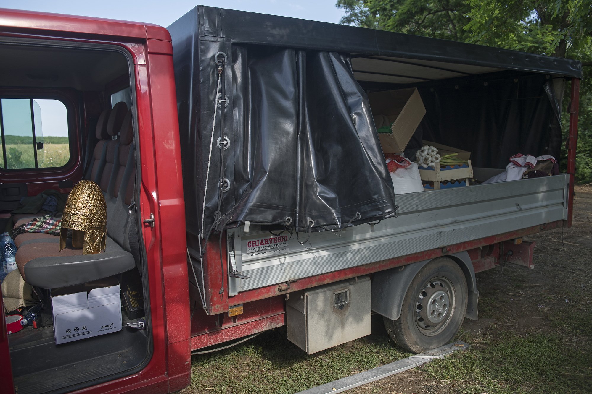 A replica of a golden Dacian helmet is seen as re-enactors are packing at the end of the festival