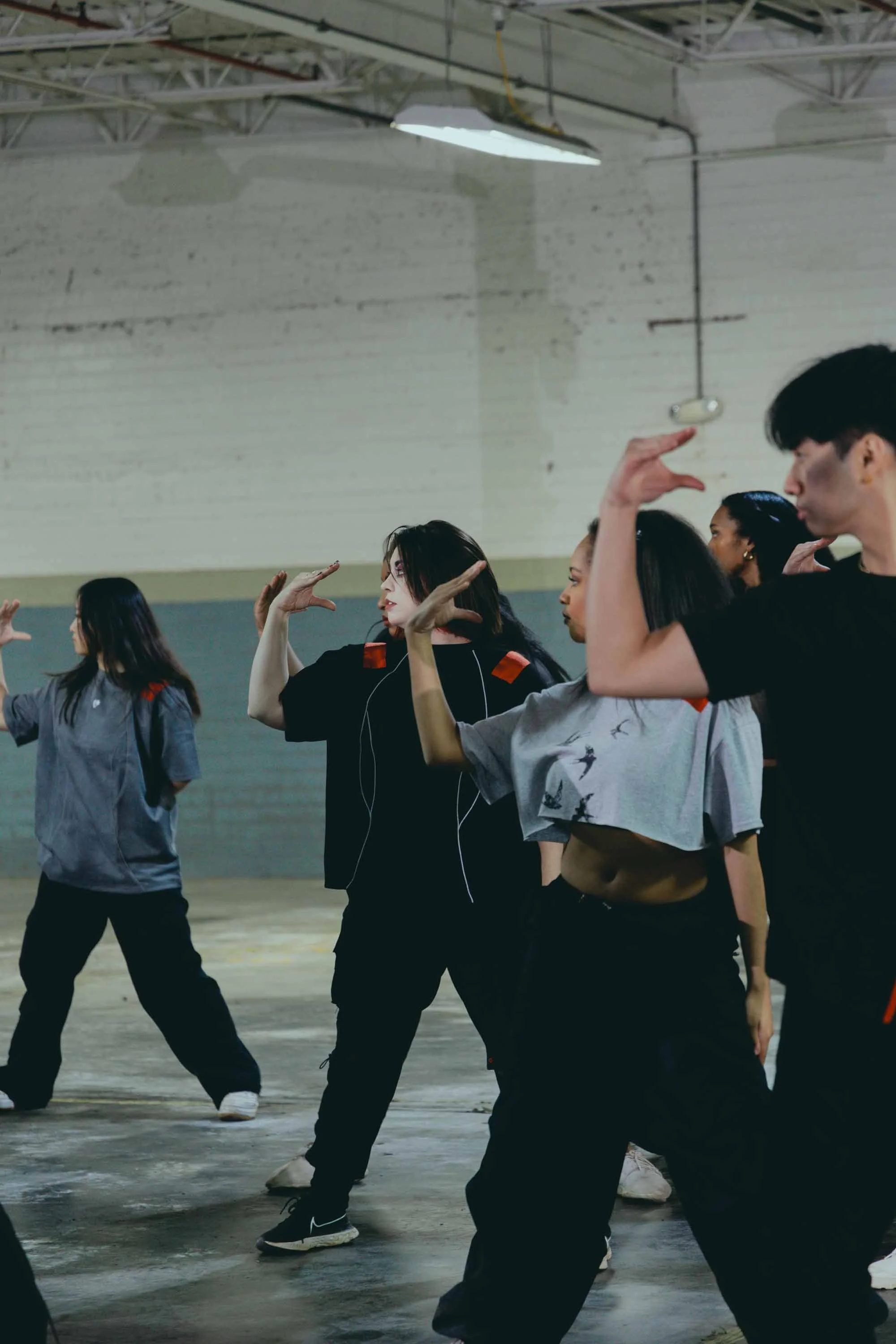 Dancers executing powerful ensemble movement in “At The Risk,” a narrative dance project created by April L. McLaurin.