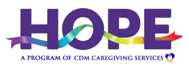 The word 'HOPE' with a multicolored ribbon crossing through the letters, and the phrase 'A program of CDM caregiving services' below, along with a small heart-shaped logo with a yellow and blue dove.