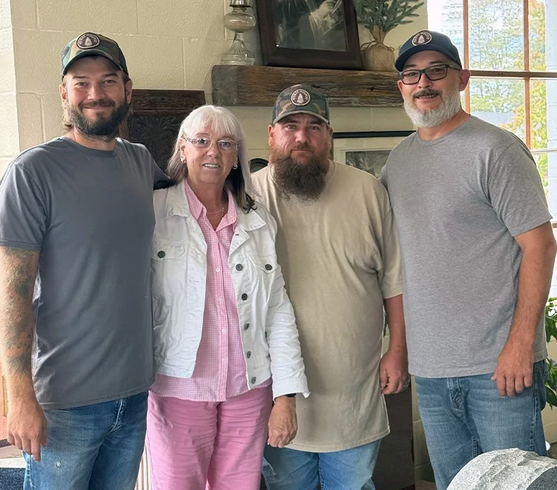 A group portrait of four employees of Peebles Monument Co.