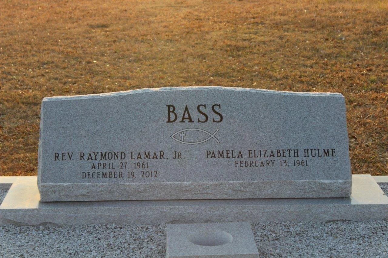 Gravestone for Rev. Raymond Lamar Jr. and Pamela Elizabeth Hulme, with the surname 'Bass' and a Christian fish symbol. The dates for Raymond Lamar Jr. are April 27, 1961 to December 19, 2012, and for Pamela Elizabeth Hulme, February 13, 1961.