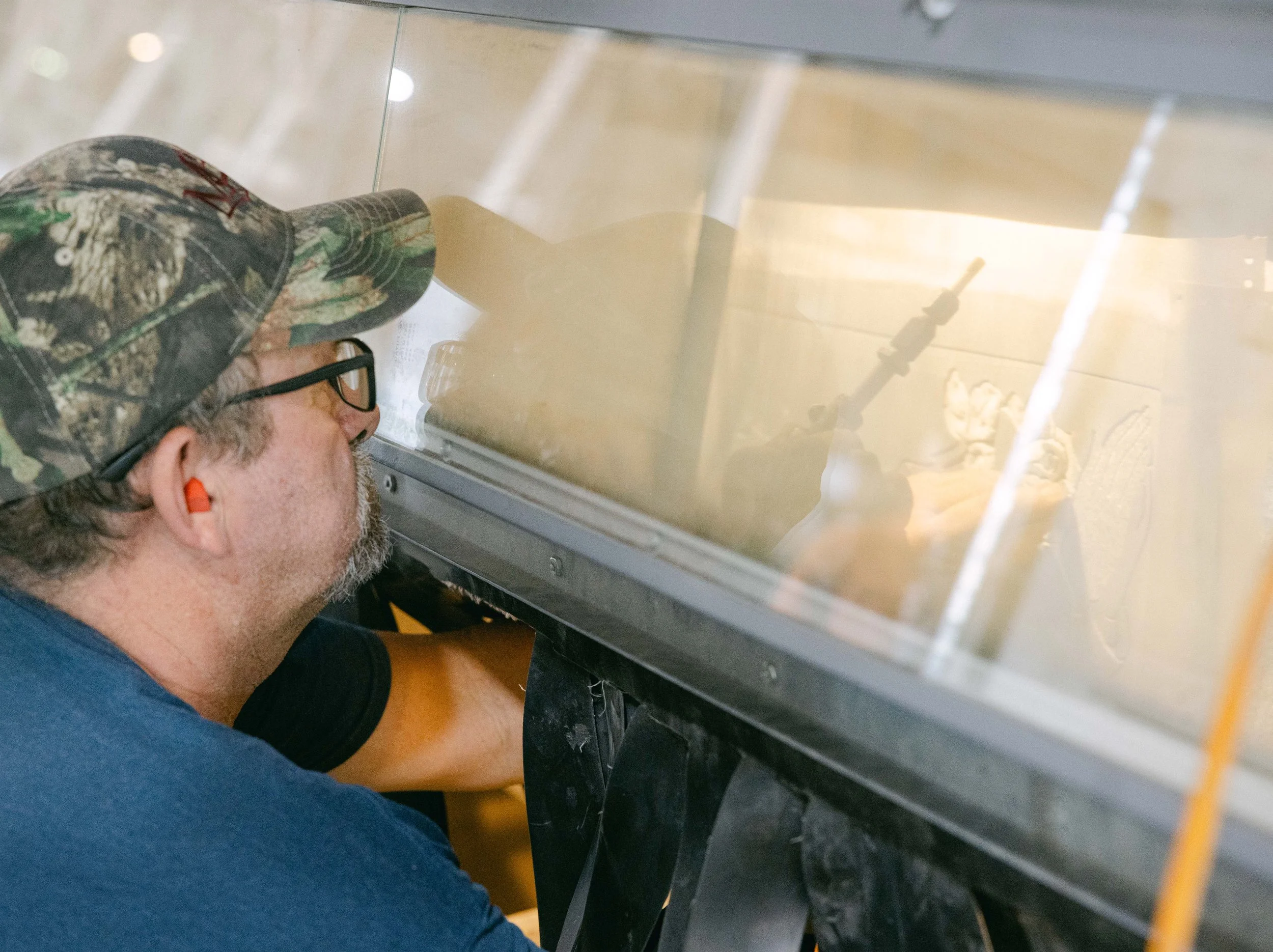 A man checking his work and using an air blaster on it