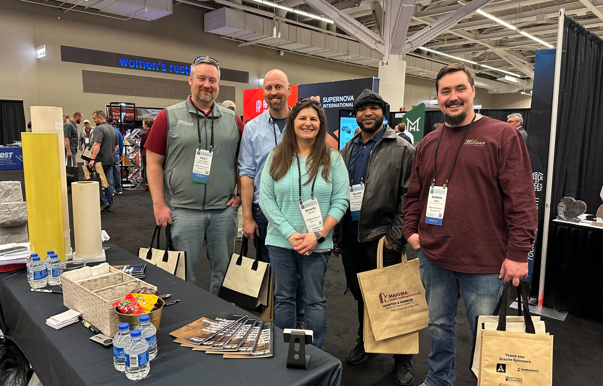 The u-blast team with customers posing for the camera at a tradeshow in 2025