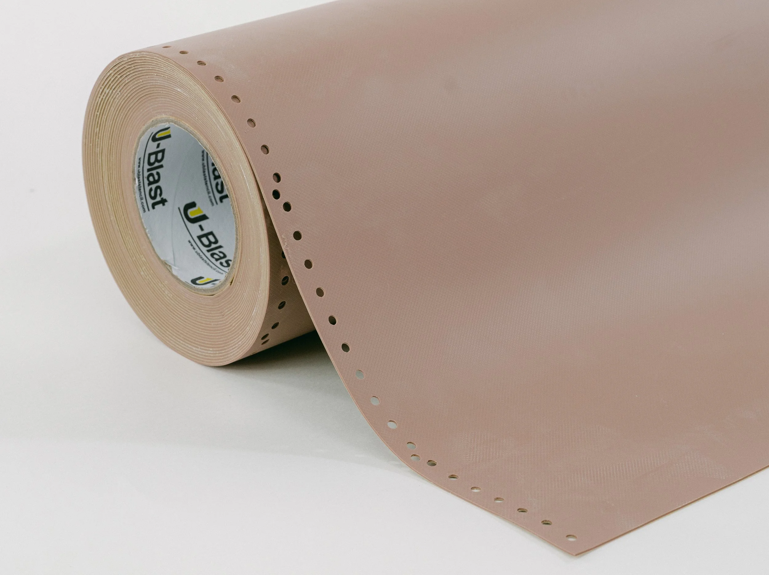 A ublast stencil product in brick color roll on its side on a plain background