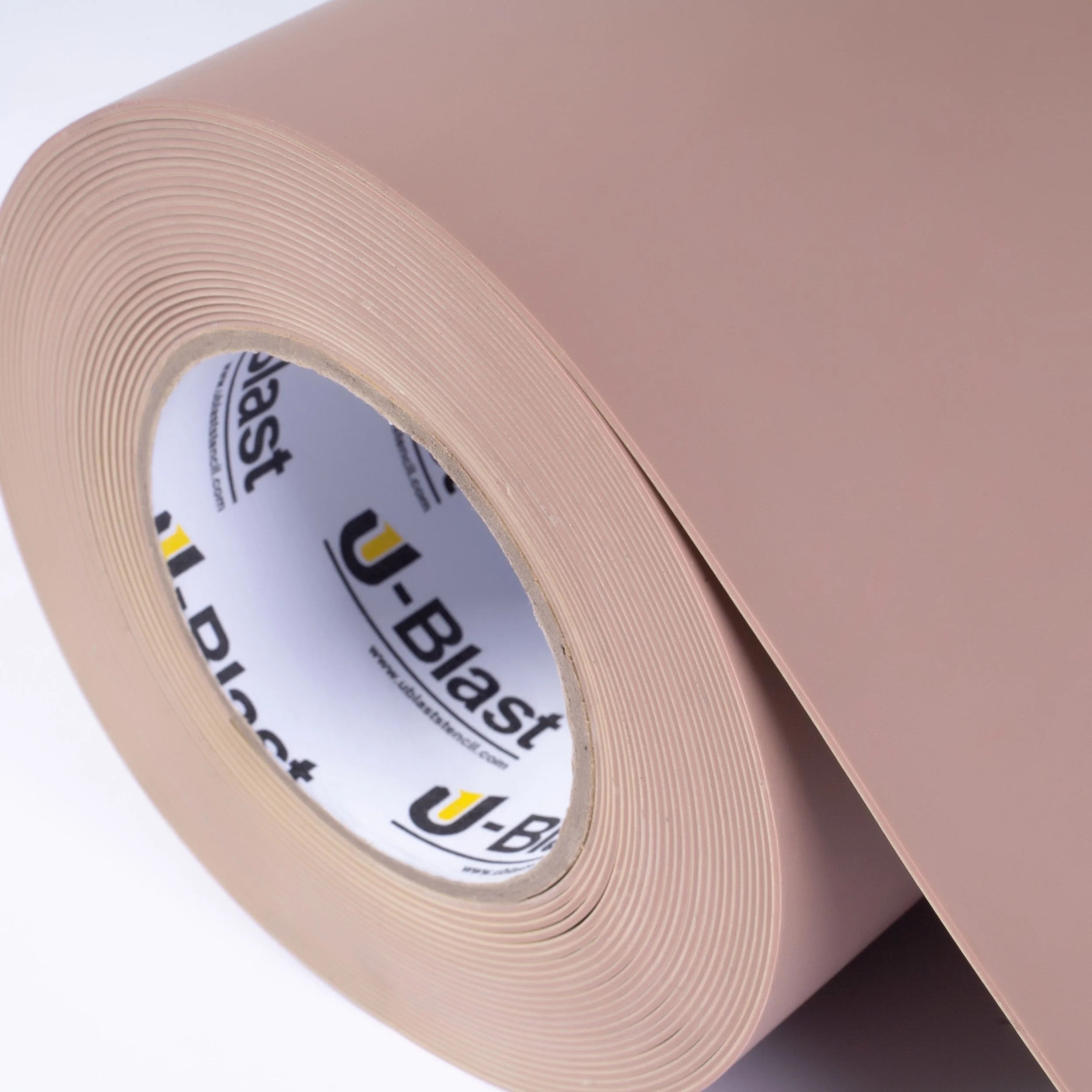 A roll of pink rubber stencil with small holes and a U-Blast brand inner core.