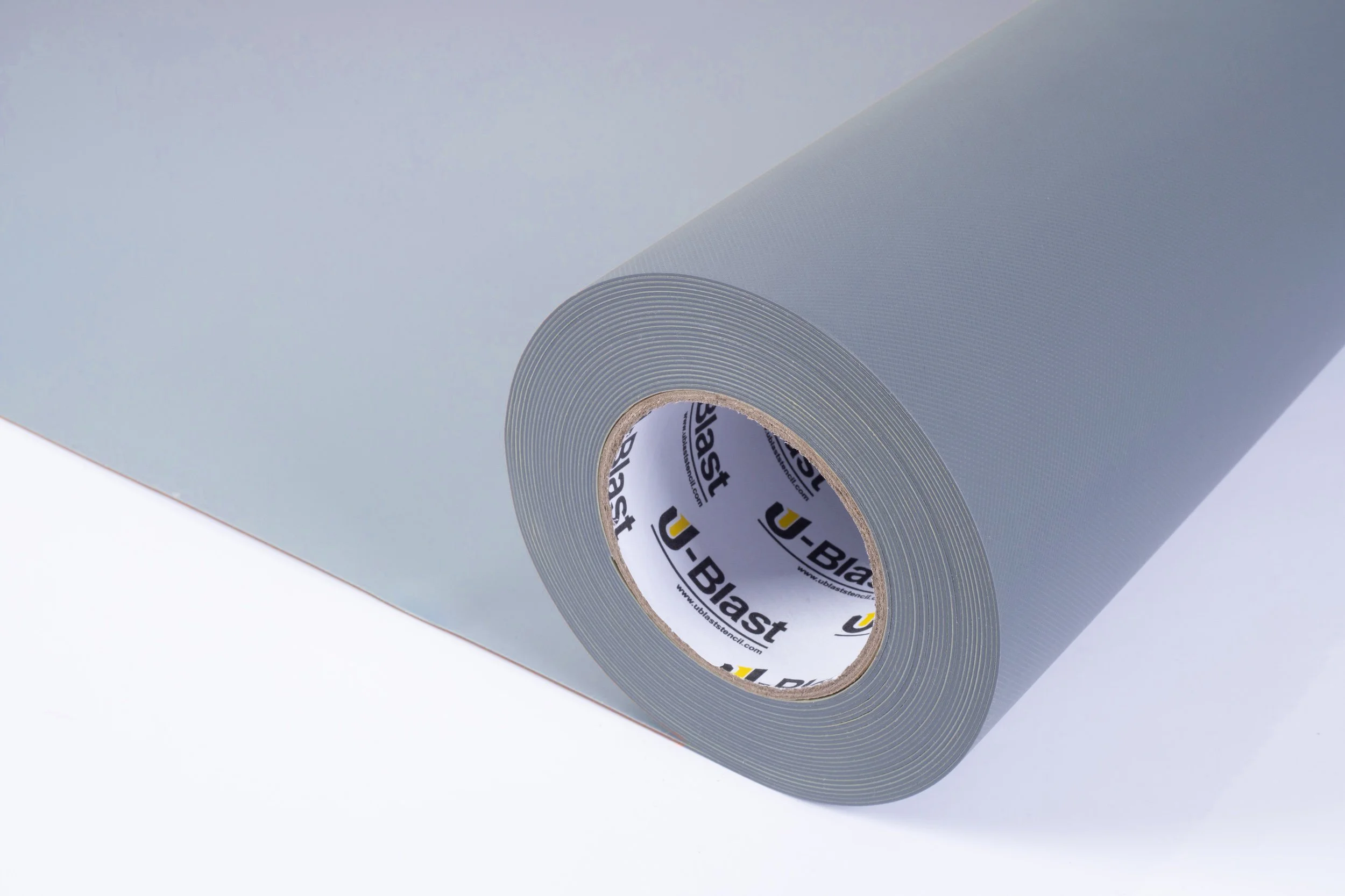 A roll of gray adhesive tape partially unrolled on a white surface.