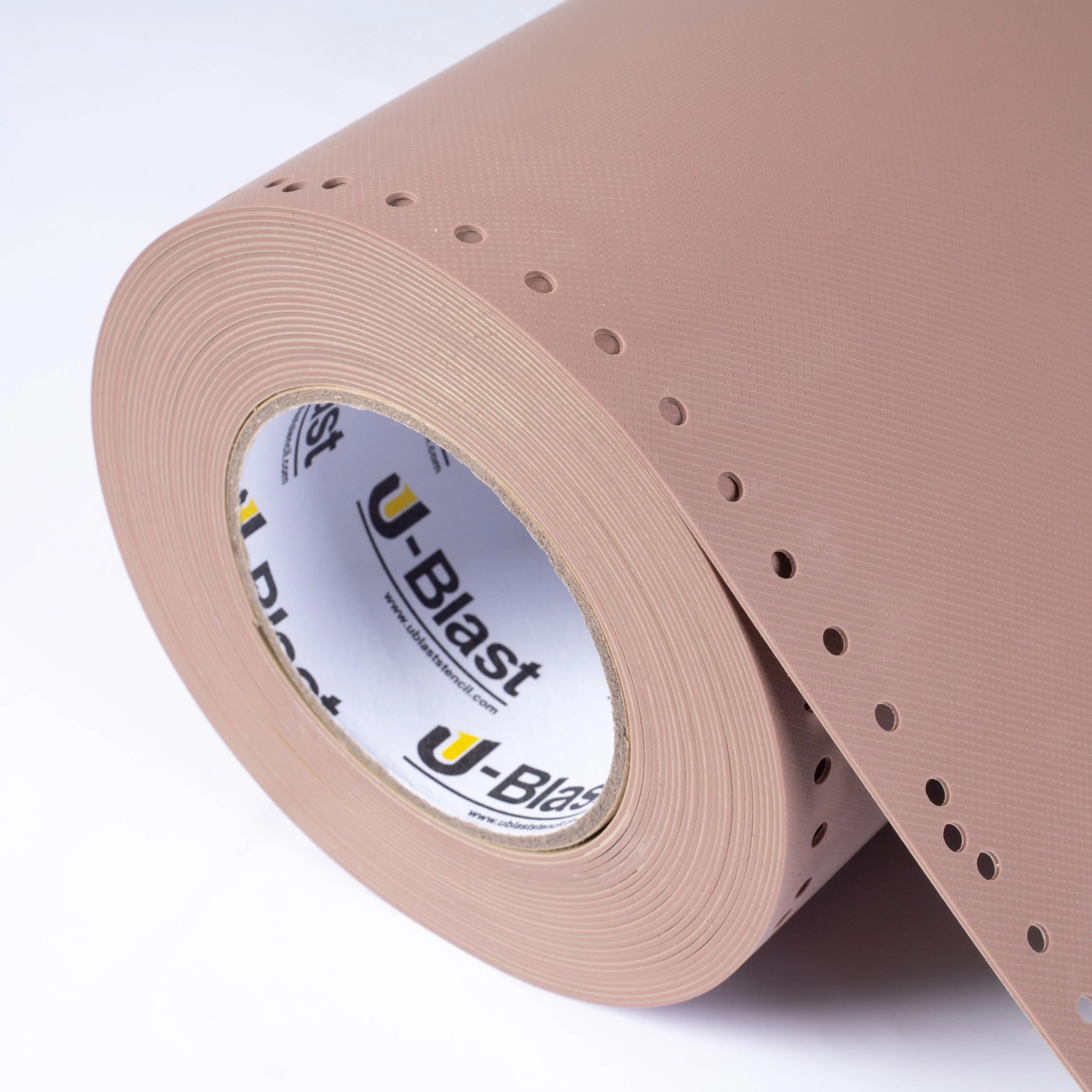 A roll of pink rubber stencil with small holes and a U-Blast brand inner core.
