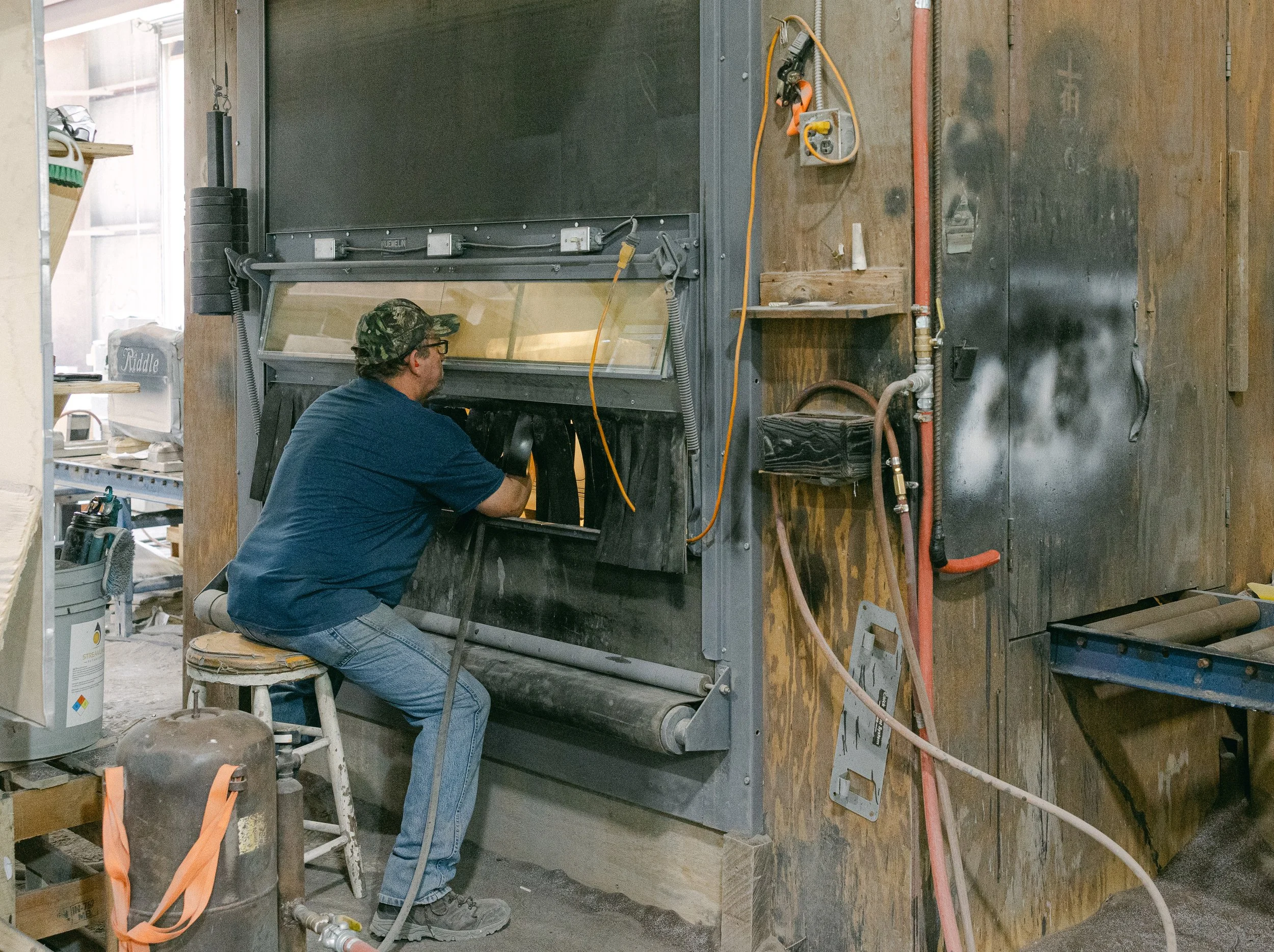 A man in a workshop in deep focus
