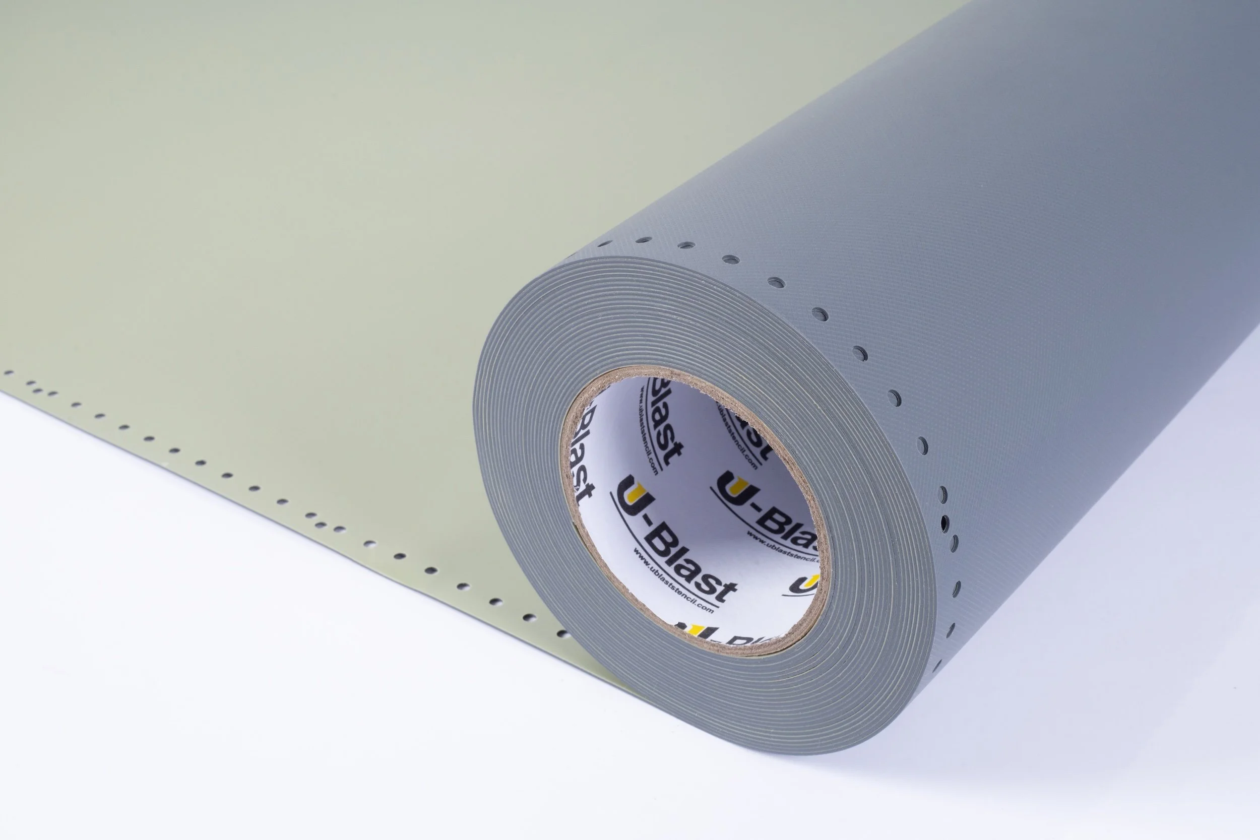 A roll of perforated light gray self-adhesive foam or rubber edge banding material on a white surface.