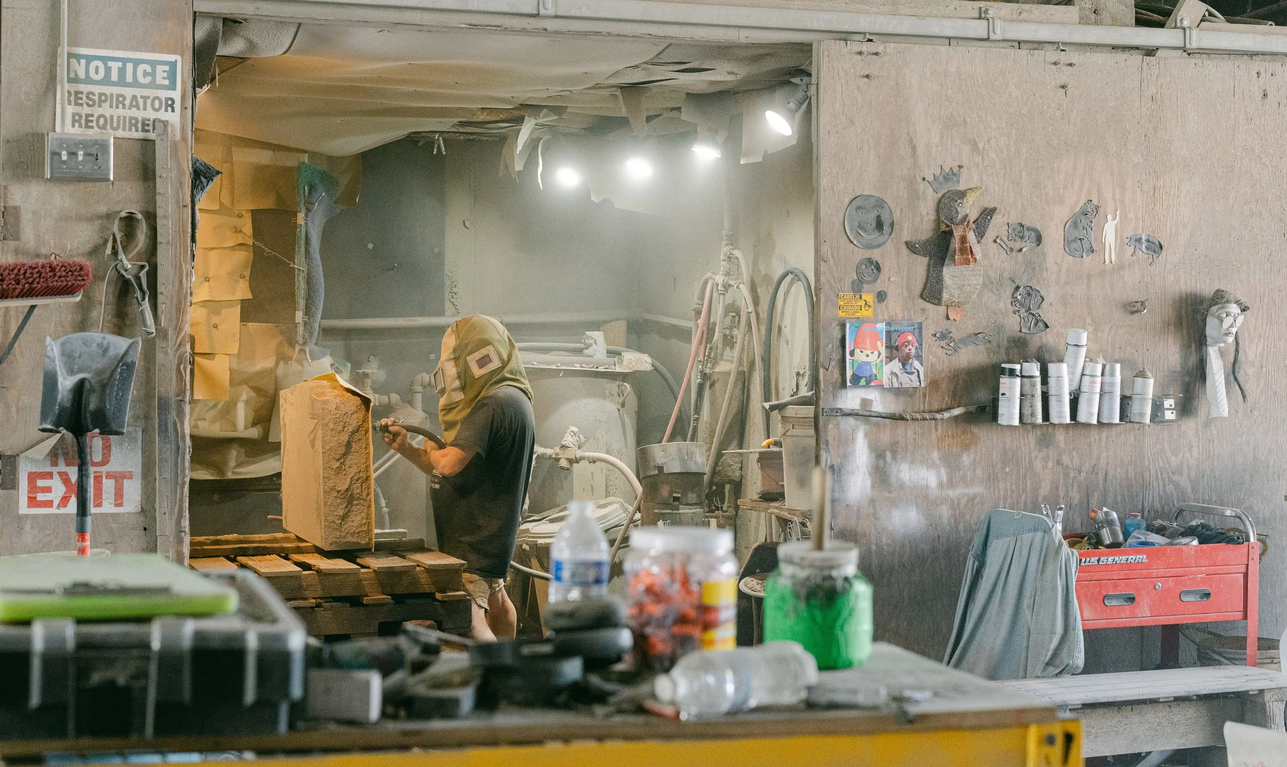 Sandblasting a headstone in a sandblasting shop