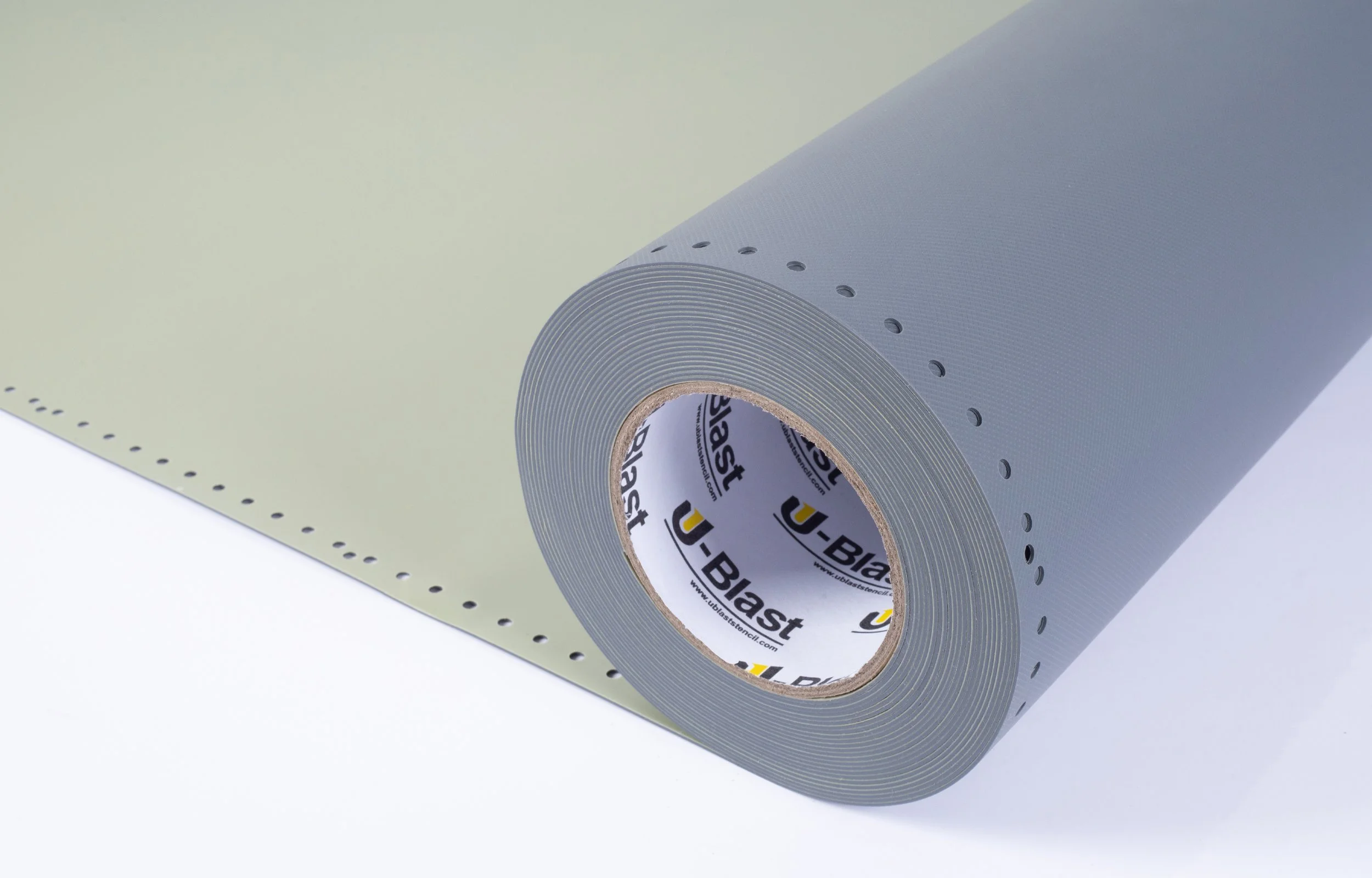 A roll of blue and green U-Blast rubber stencil on a white surface