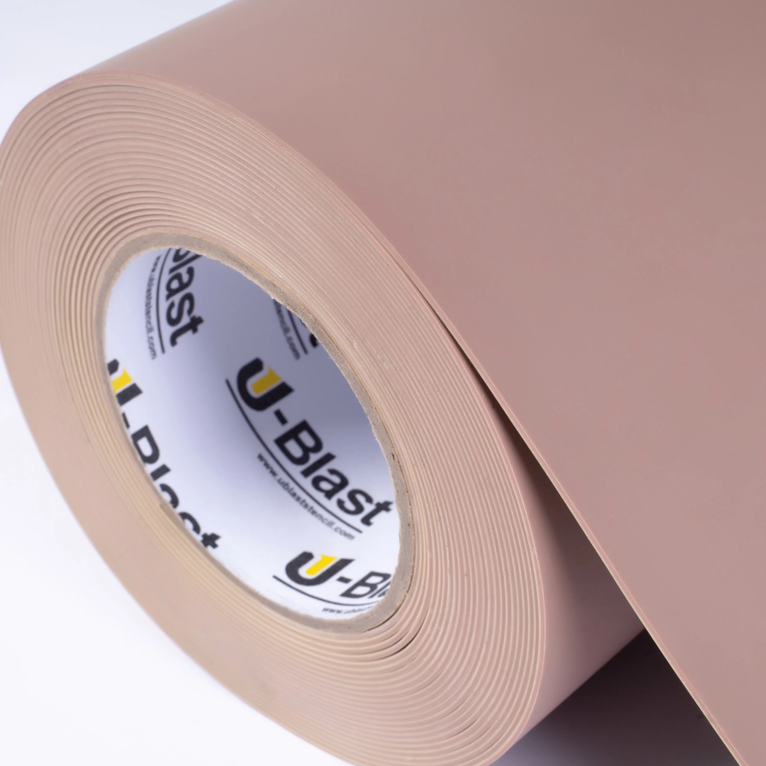 A roll of pink rubber stencil with small holes and a U-Blast brand inner core.