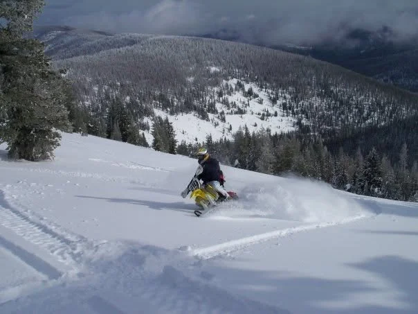 Snowbike rider carving powder on an Idaho mountain slope