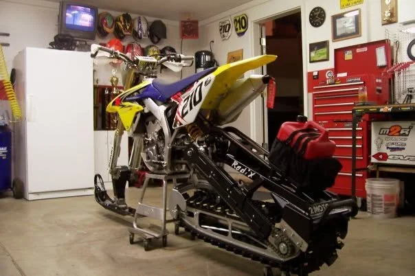 Early Suzuki snowbike conversion in a garage workshop