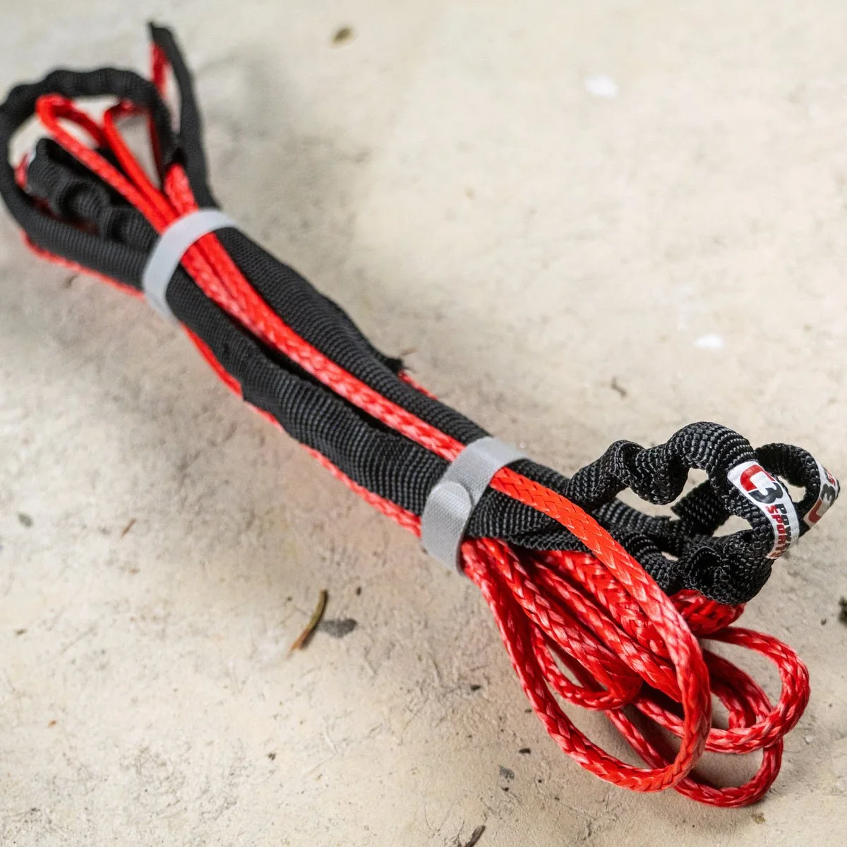 C3 two-piece snowbike tow strap bundled with protective sleeves and storage wraps