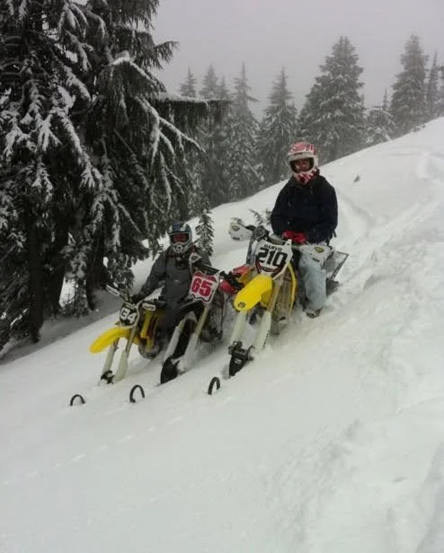Riders with Timbersled Mountain Horse snowbikes on a snowy forest hillside in December 2010