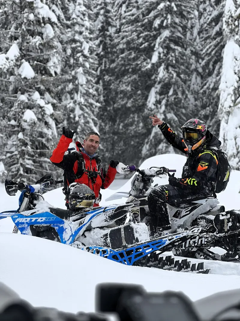 Two riders with MTN.TOP snowbikes in a snowy forest