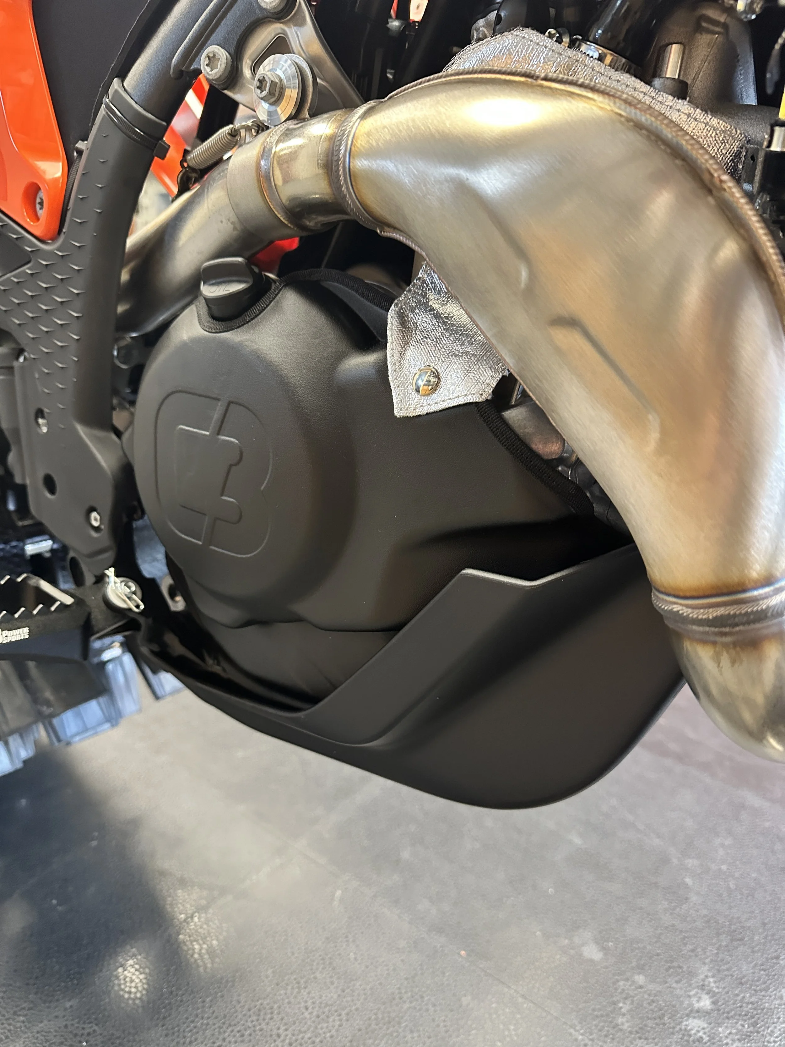 KTM OEM skid plate fitted beneath a C3 Engine Skin, right-side view