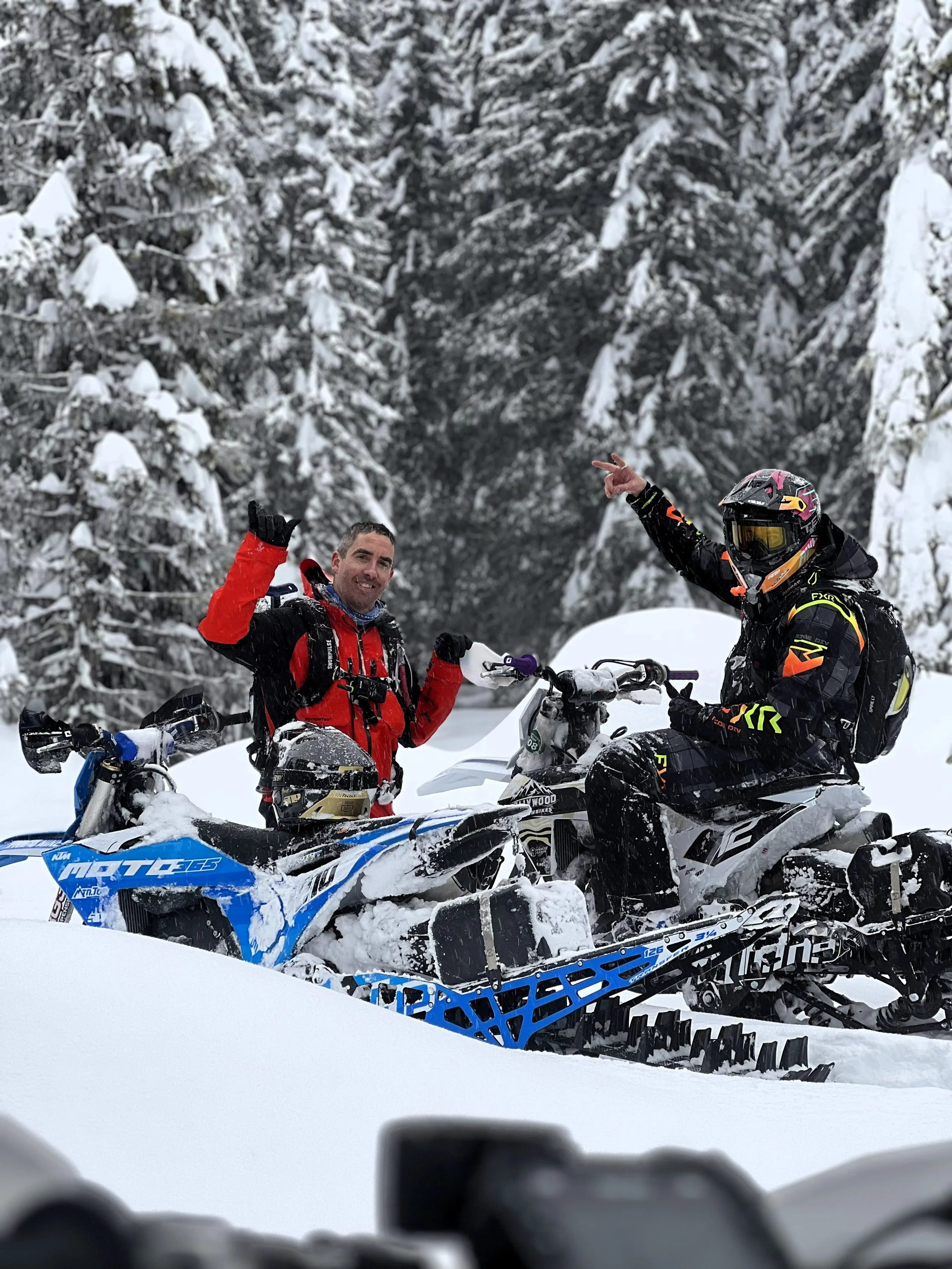 Two riders with MTN.TOP snowbikes in a snowy forest