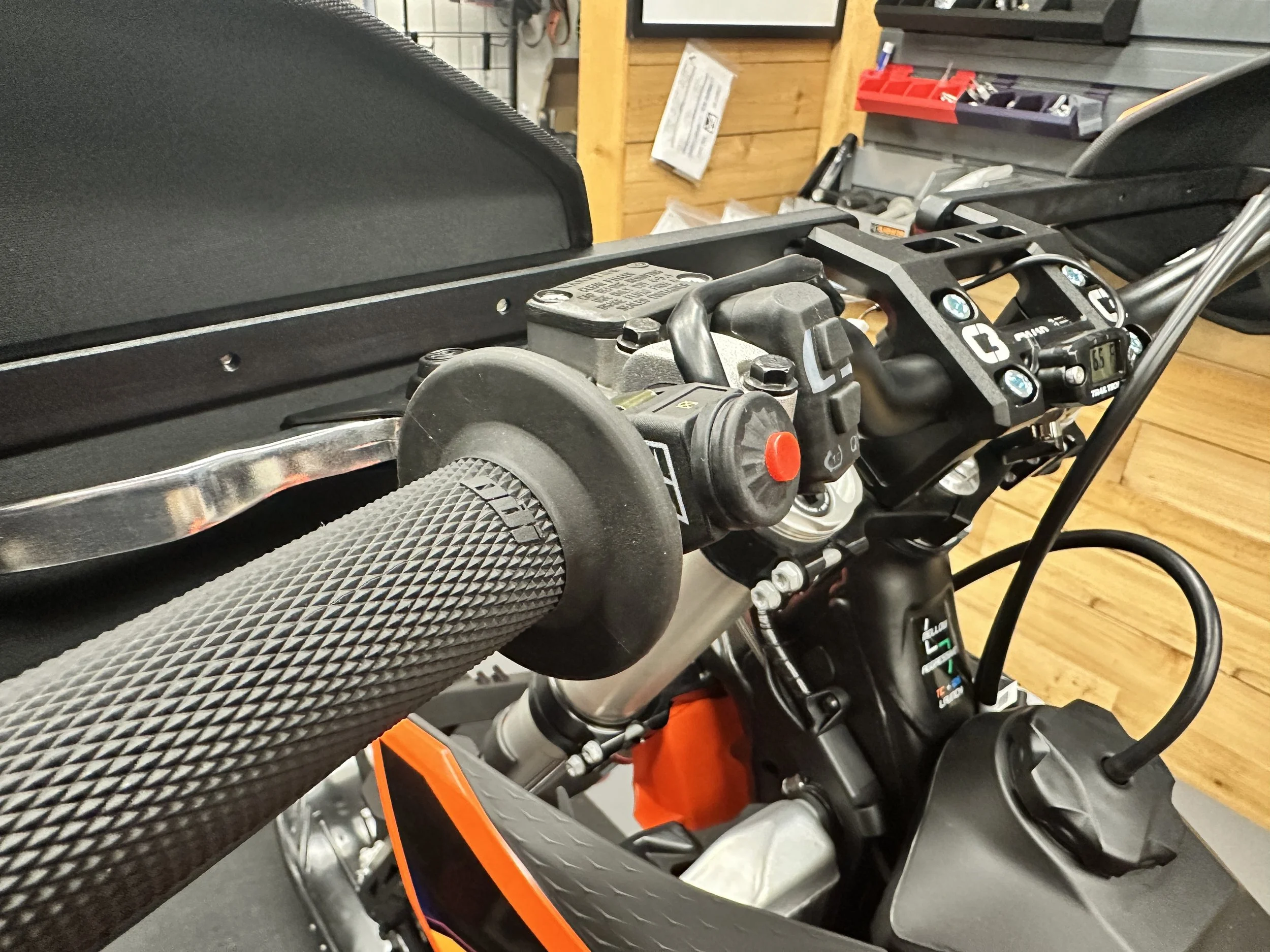 Red Nihilo stop button mounted beside the left handlebar grip