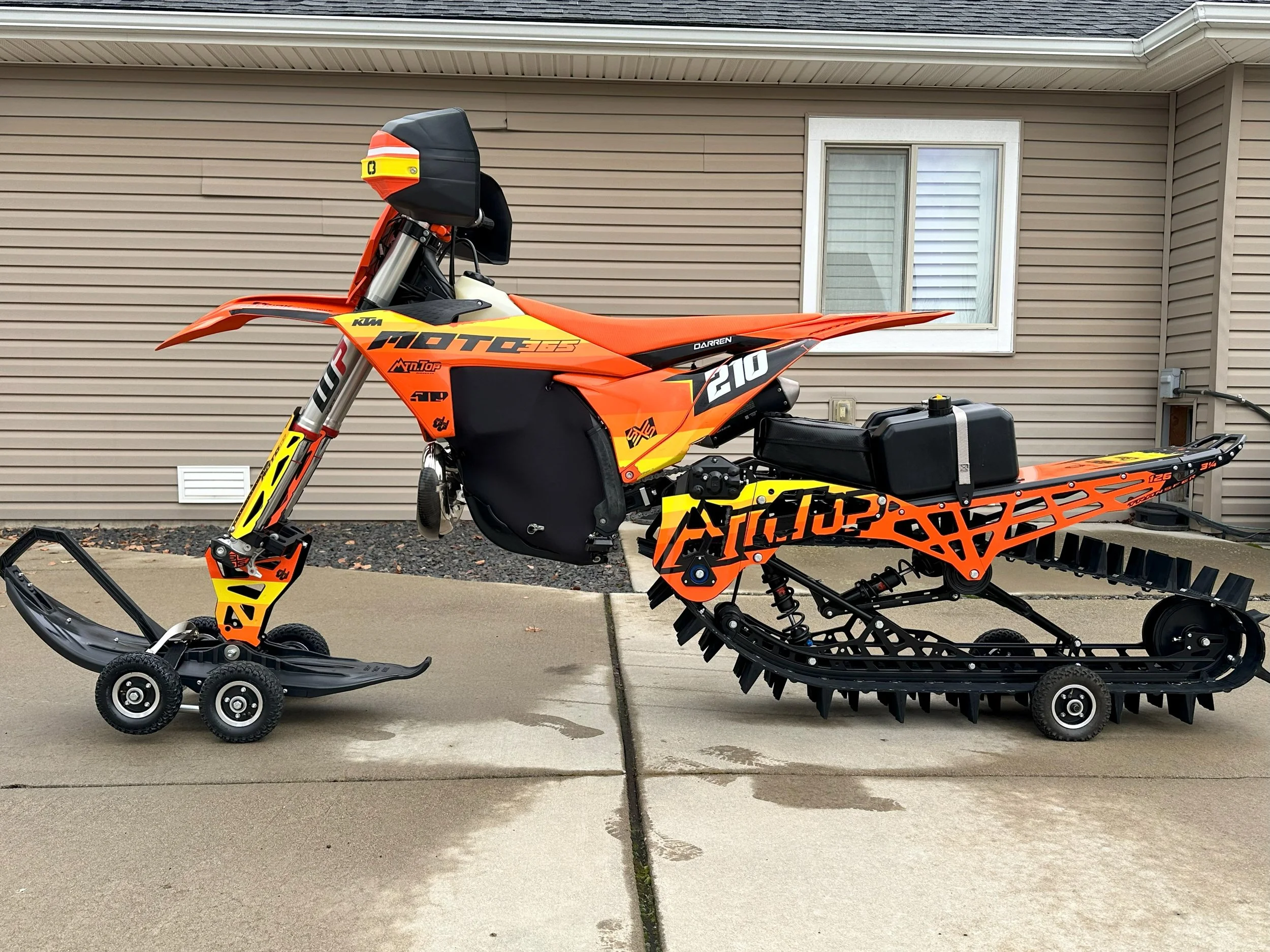 Orange and black KTM 300 XC TBI snowbike with an MTN.TOP 126 conversion kit