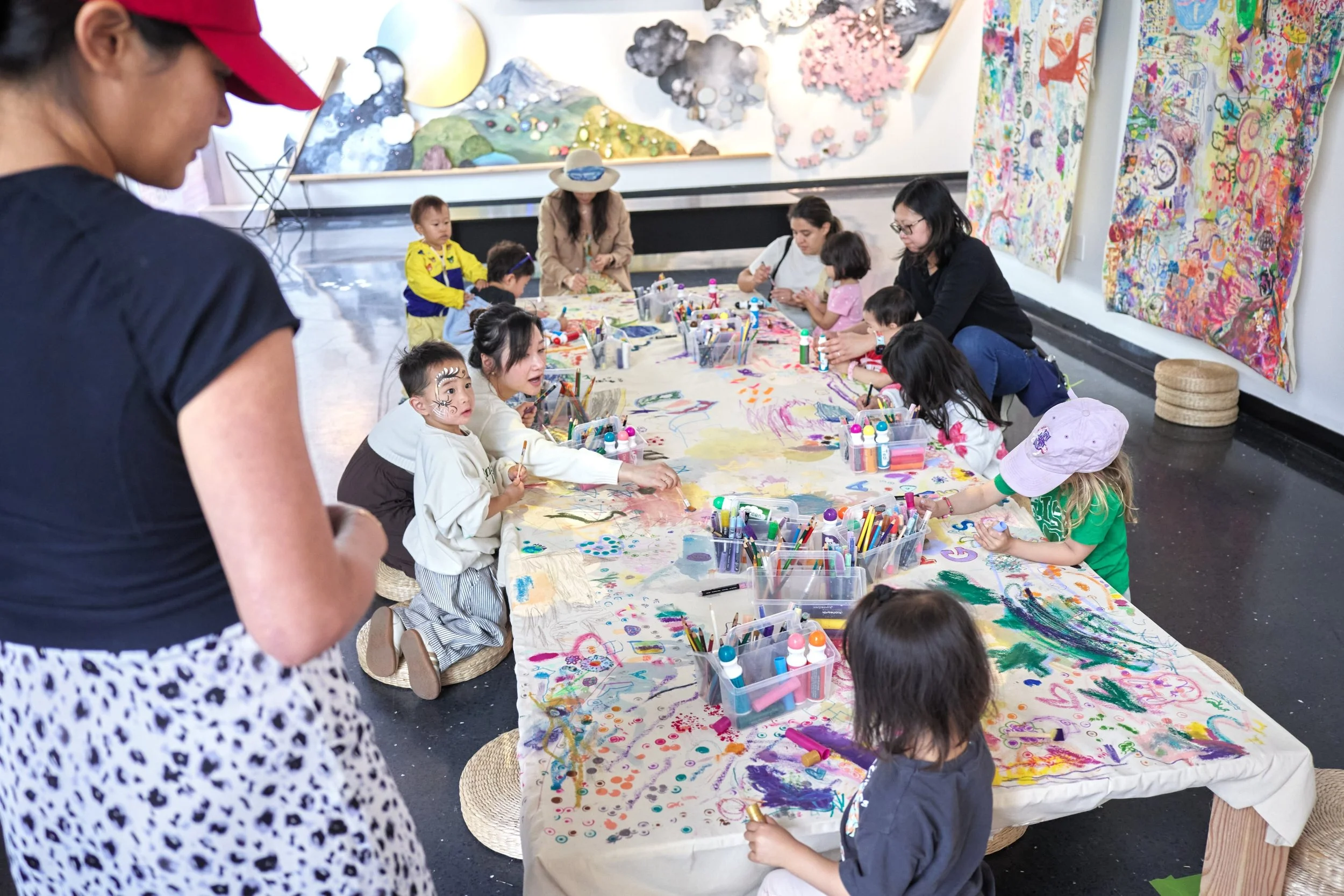 kids and grownups engaging in a public art activity and interactive art exhibition.
