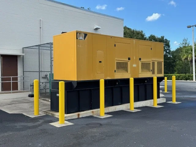 Yellow industrial generator installed outside a commercial building