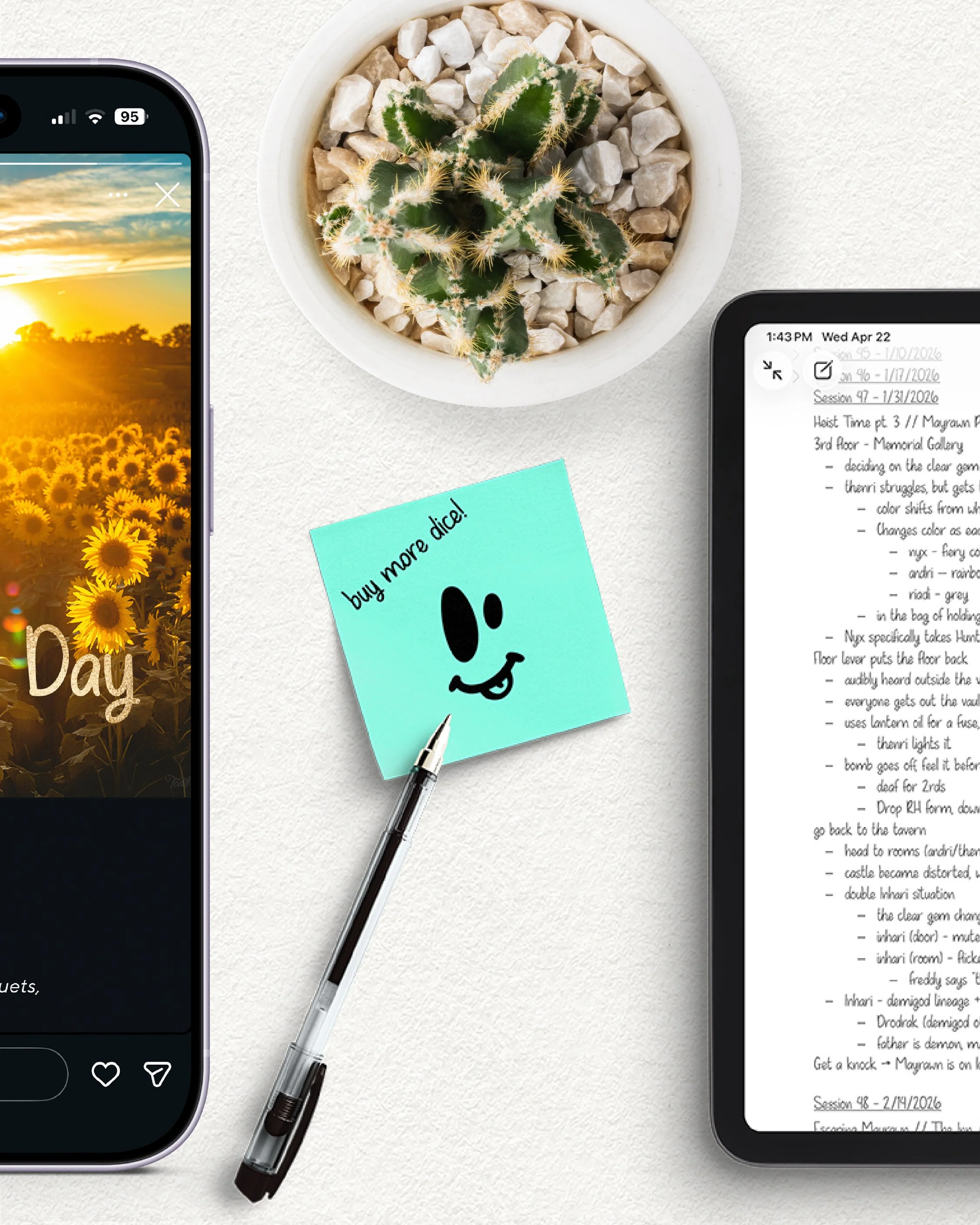 Top view of a white table with a small potted cactus, a silver pen, a smartphone with a sunset sunflower image on the screen, and a second device displaying handwritten notes, with a light blue sticky note partially visible.