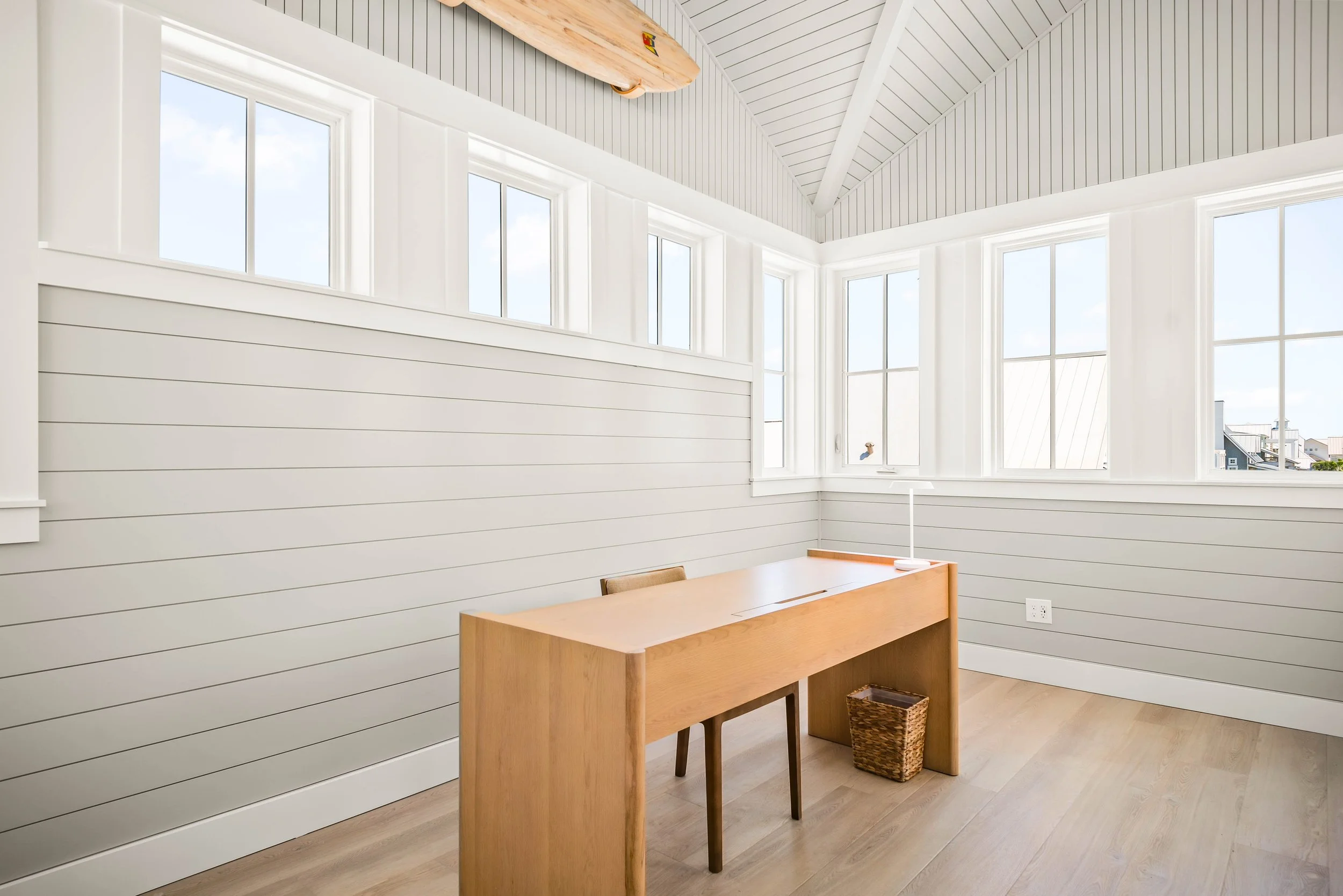 Minimalist Tower Office in Modern Coastal Home with Muted White and Gray Color Palette. Surfboard Art. Marco Polo Lane Project, Cinnamon Shore North. Port Aransas, Texas - residential design by licensed architect Stefanie Mustian, Board and Batten Ar