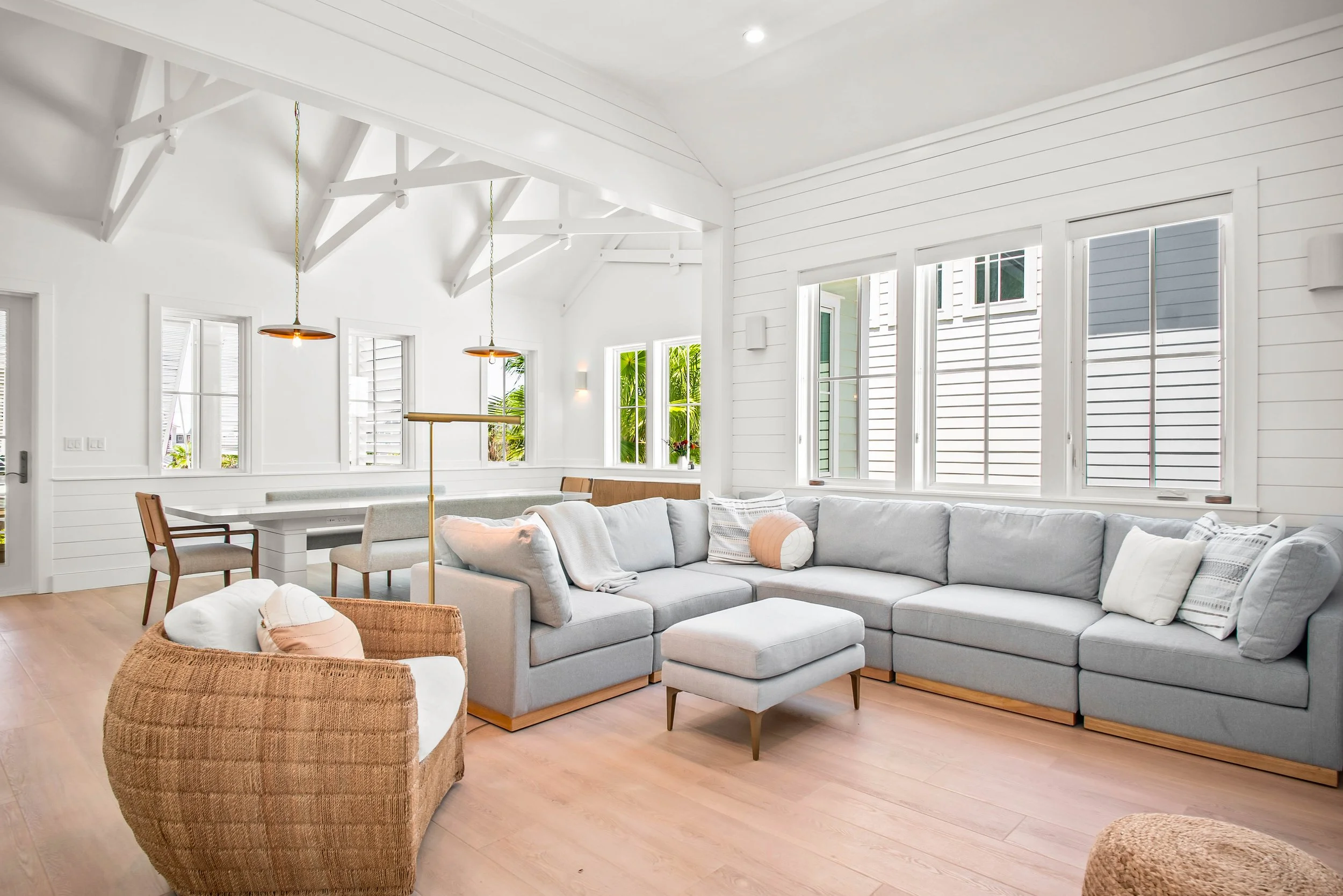 Modern Coastal Living Room Board and Batten. Rattan Minimalist Living Room Furniture. Marco Polo Lane Project, Cinnamon Shore North. Port Aransas, Texas - residential design by licensed architect Stefanie Mustian, Board and Batten Architecture and De