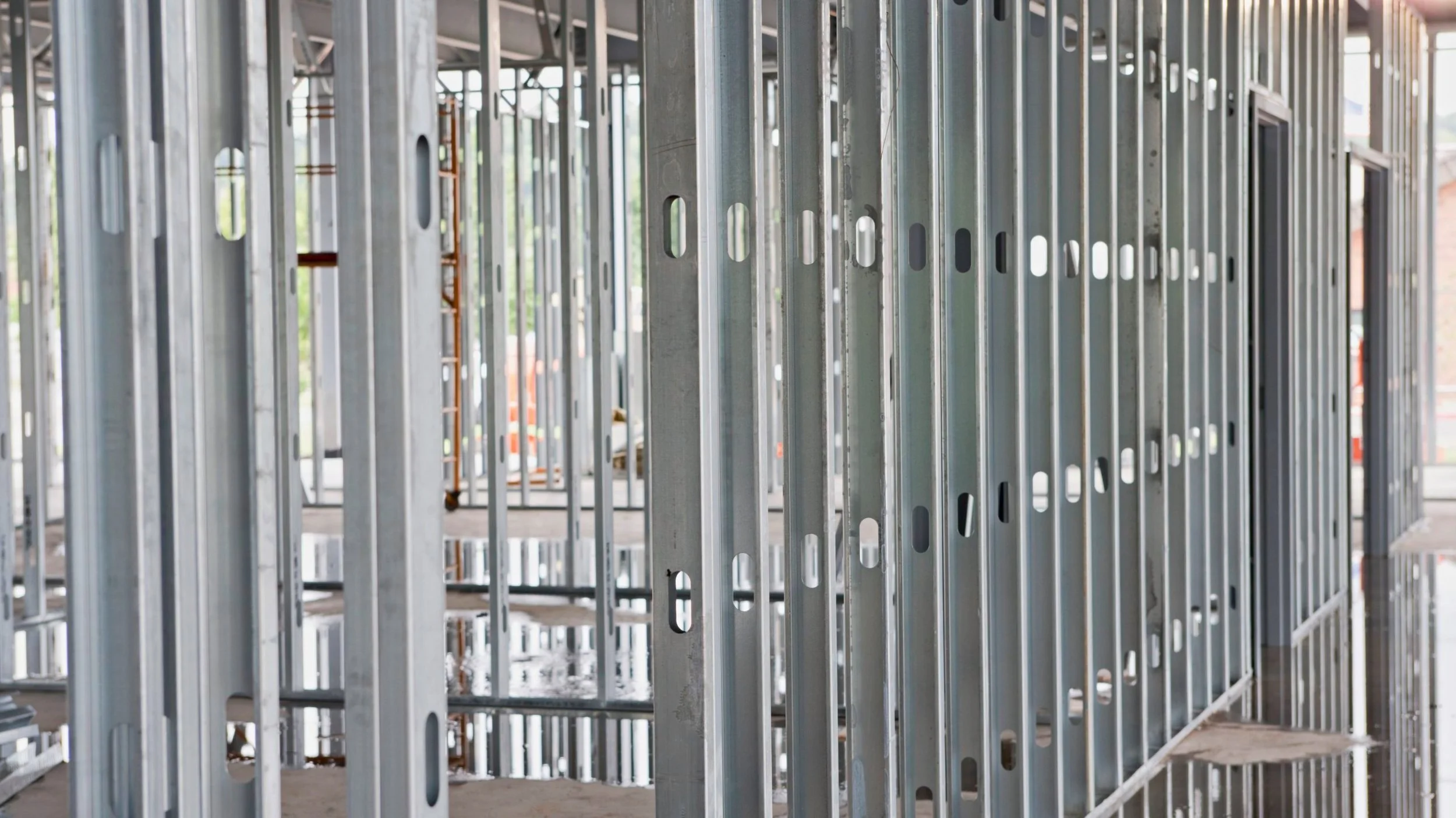 steel-beams-at-construction-site-xxl-157433571-57edd3cc3df78c690f2cb6bf-scaled.jpg