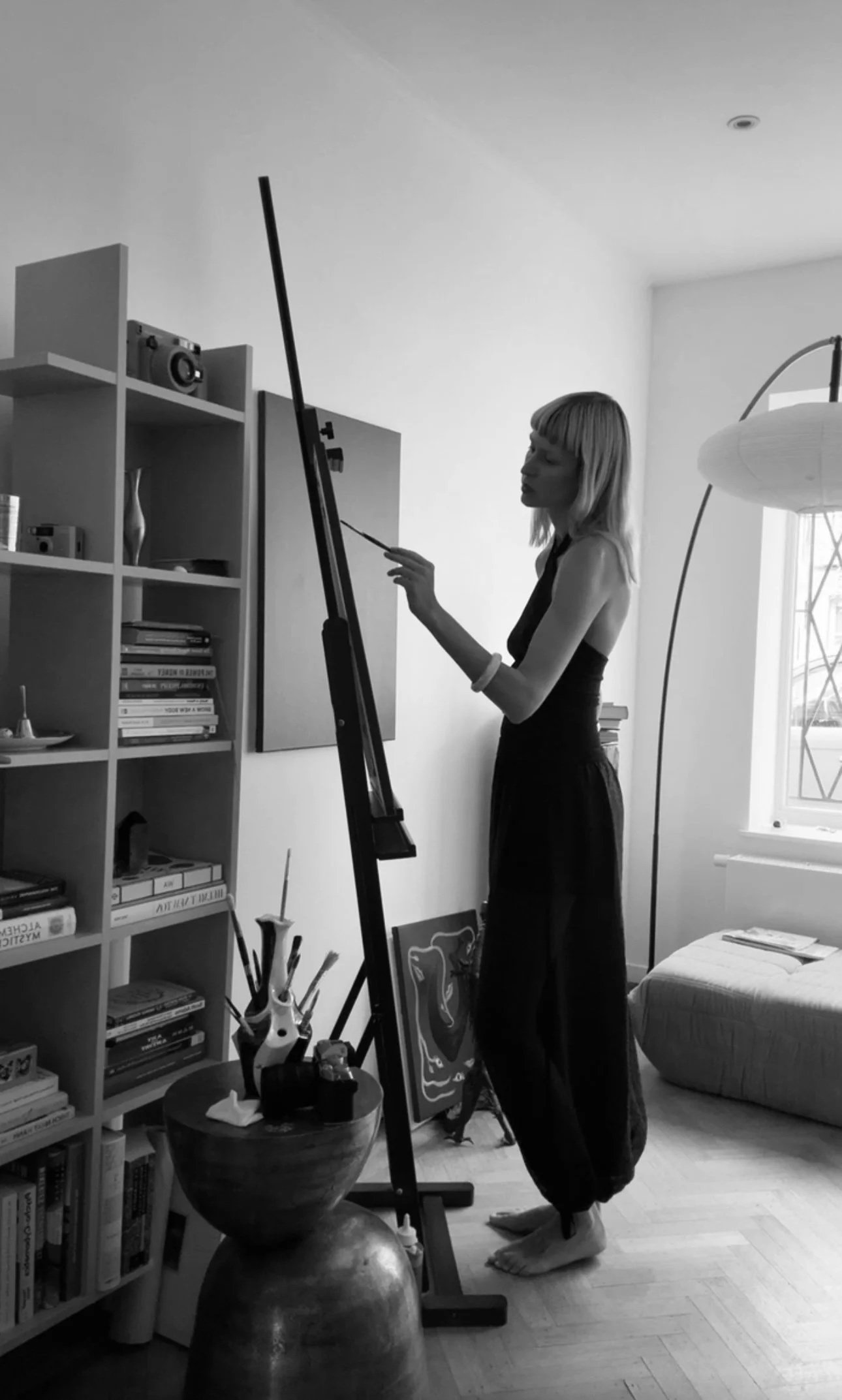 Black & White photography portraying LIVIA TIWARI while Painting an Artwork