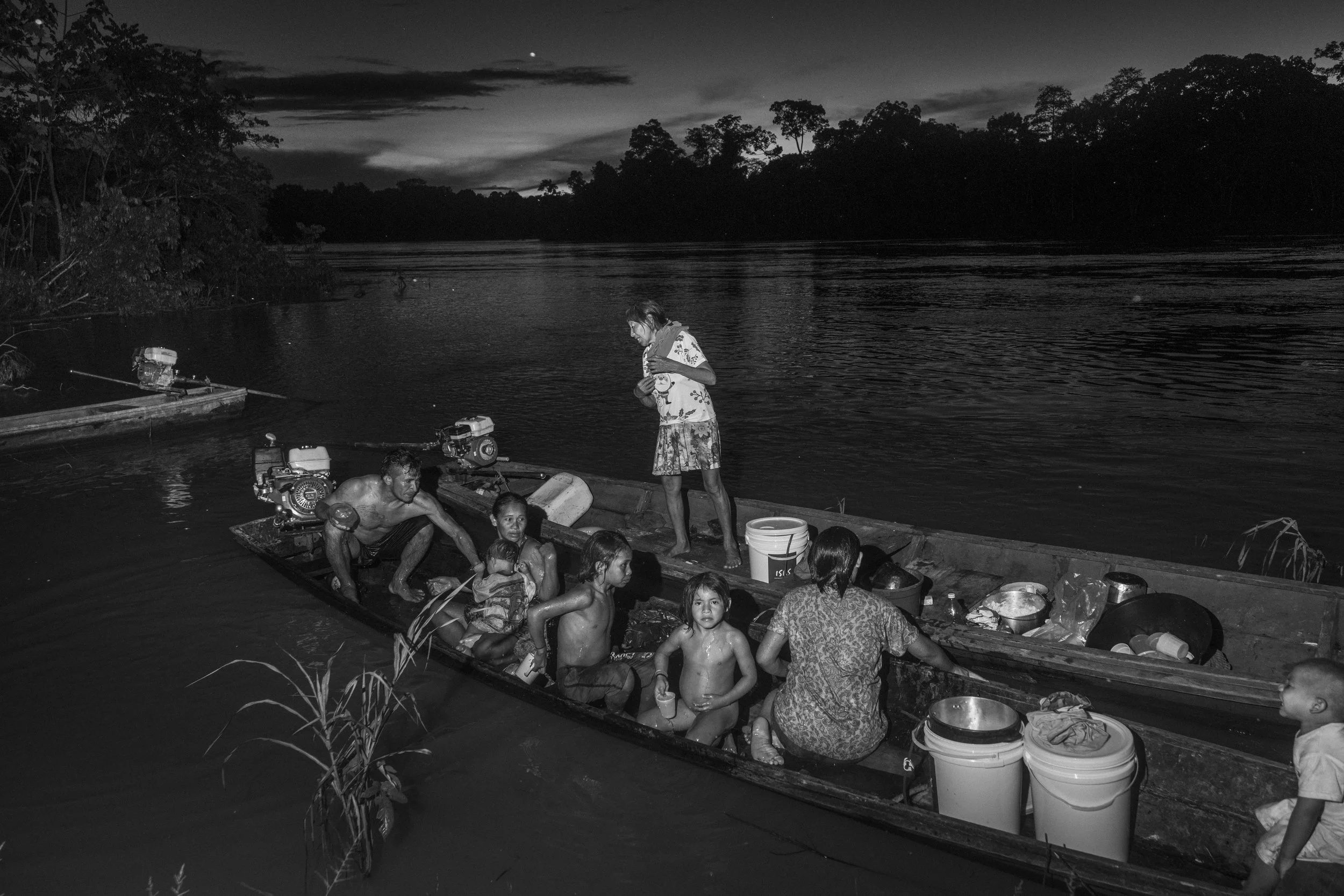 A Mayoruna family washes along the Curuca River from their boat inside the Vale do Javari Indigenous Territory.