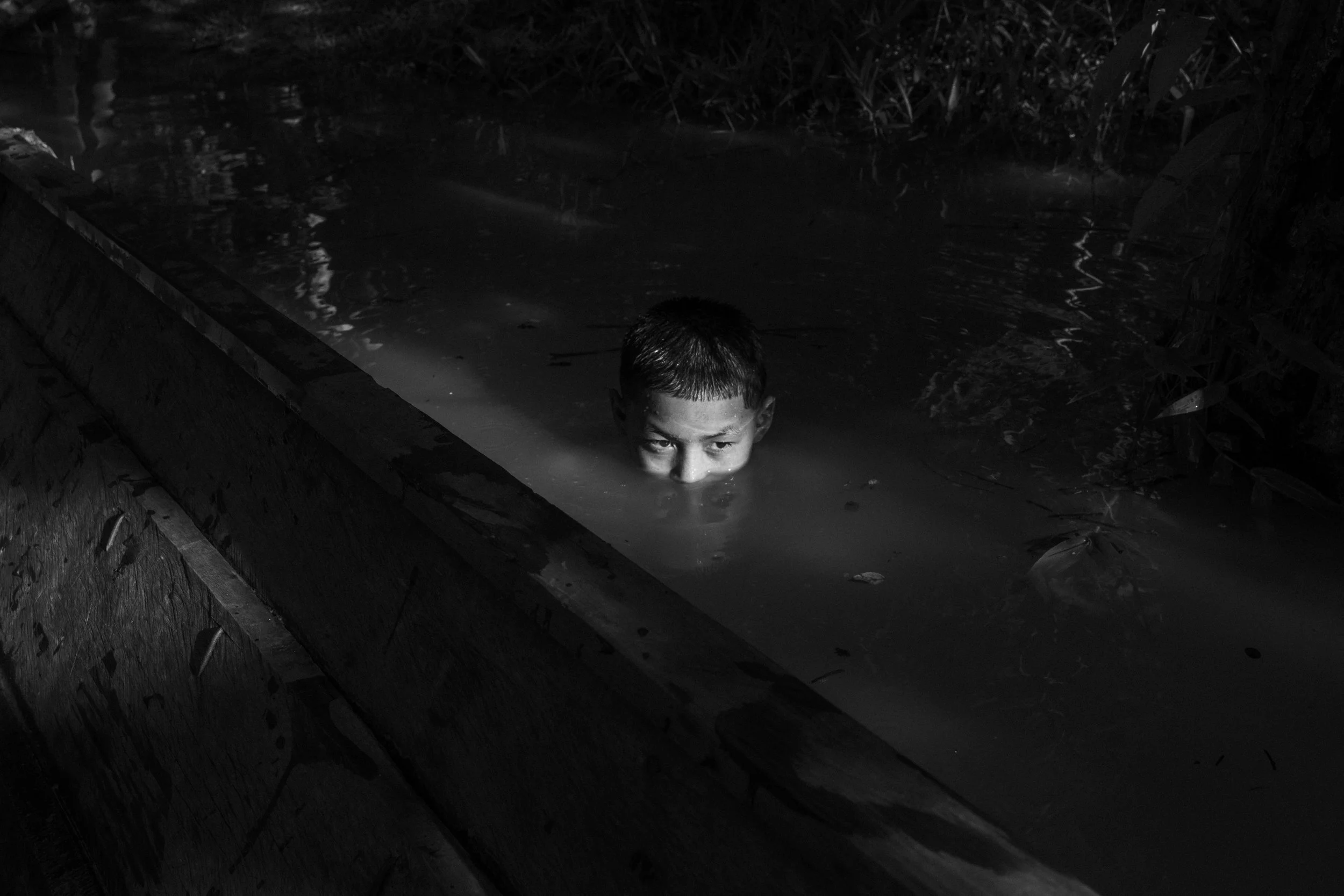 A Mayoruna child swims in the Curuçá River within the Vale do Javari Indigenous Territory.