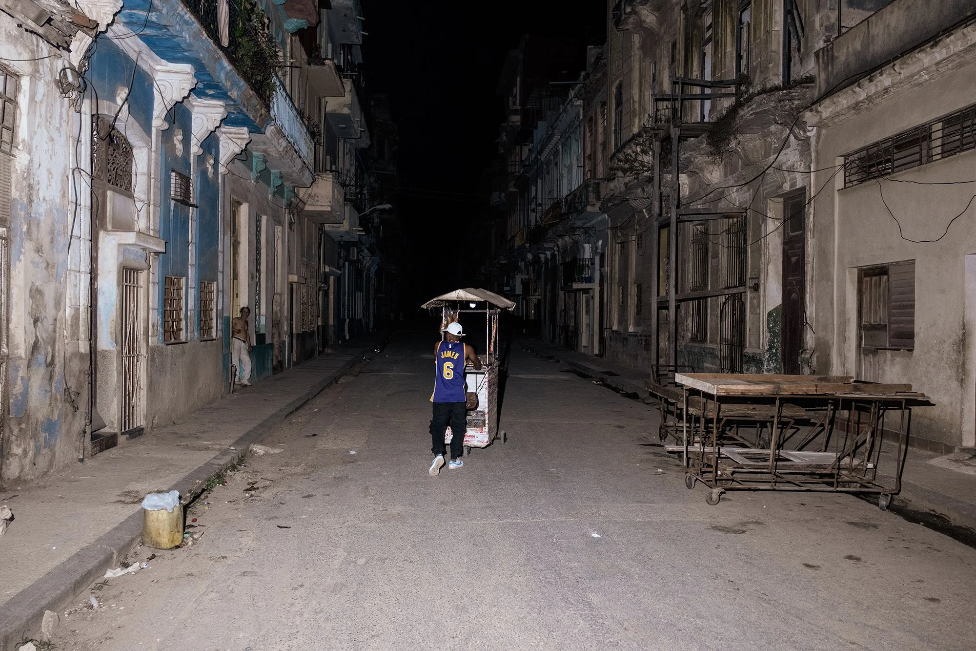 A street vendor sells bread on a street in Havana during a blackout. 