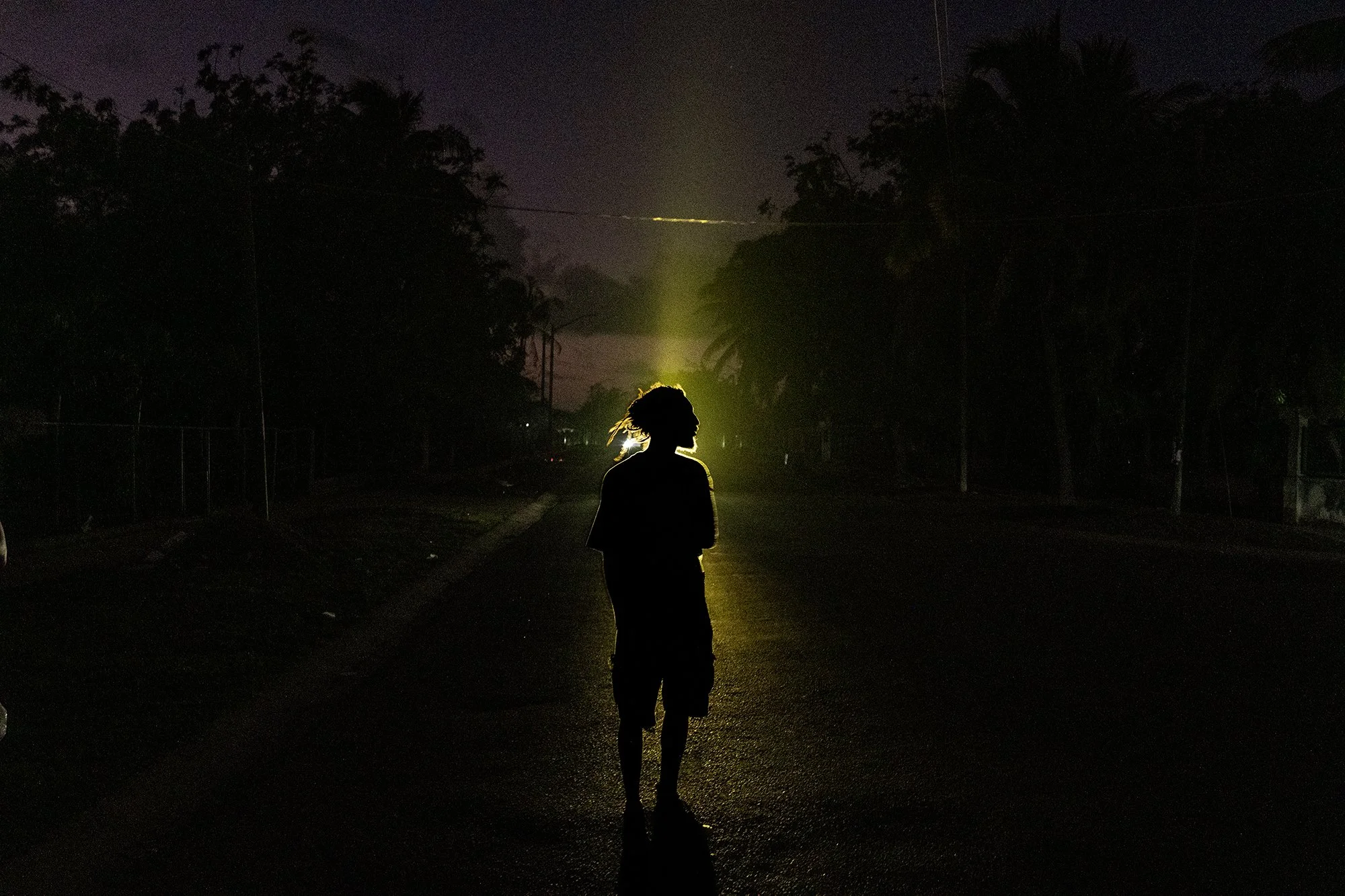 A young man seen in a street at night in Alamar, a large residential district in eastern Havana, during a blackout. 