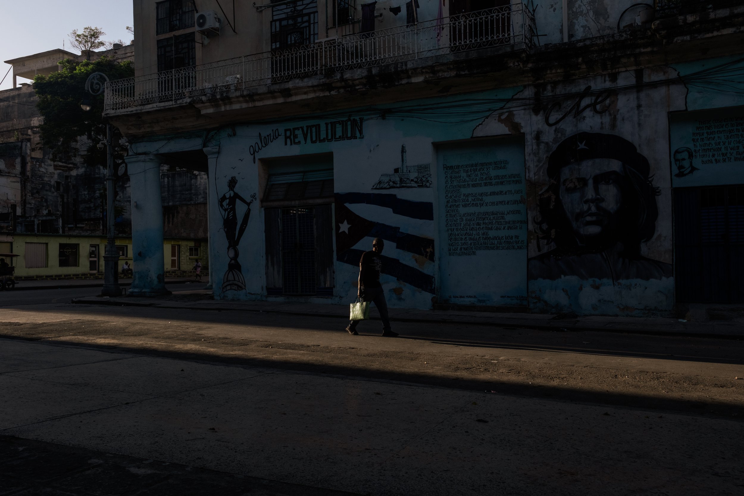 A man walkinh in a street of Havana.