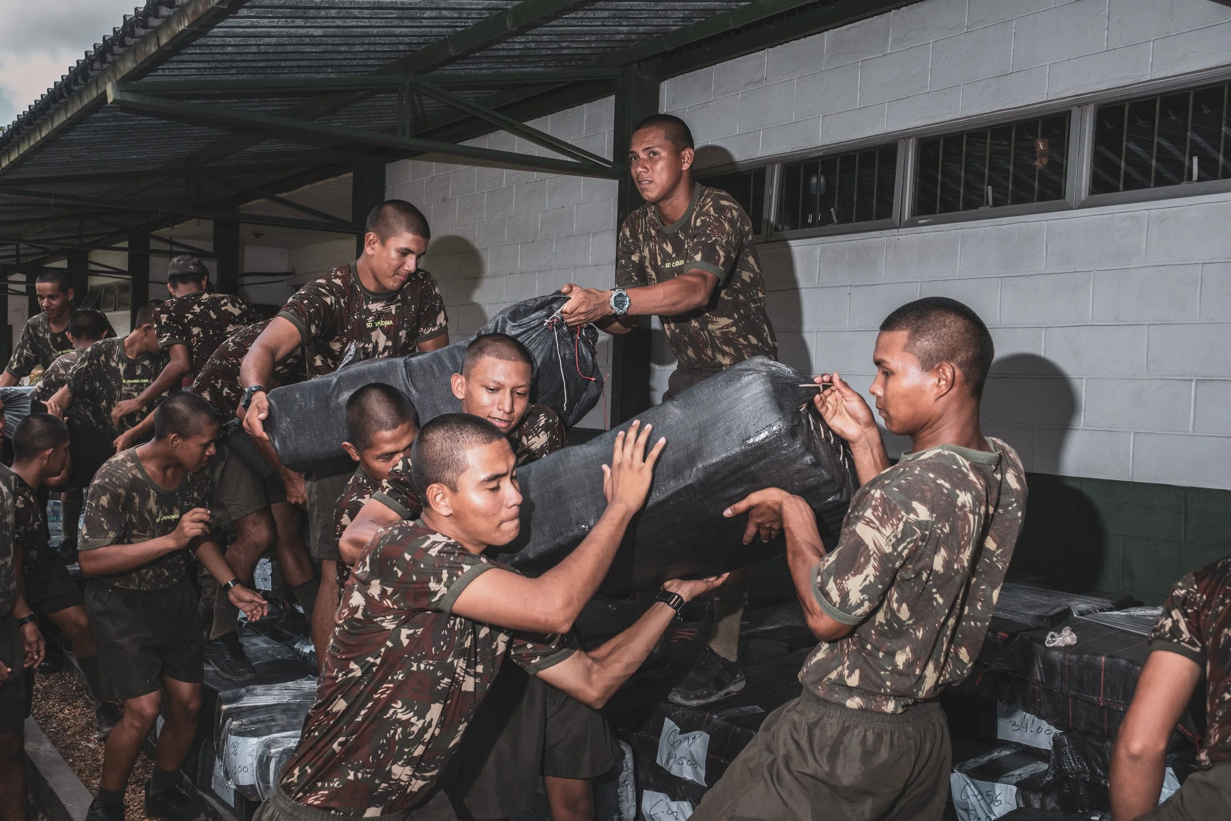 Recruits from the Brazilian Army’s 8th Battalion in Tabatinga transport 14 tons of confiscated marijuana inside the battalion headquarters before it is taken for destruction.