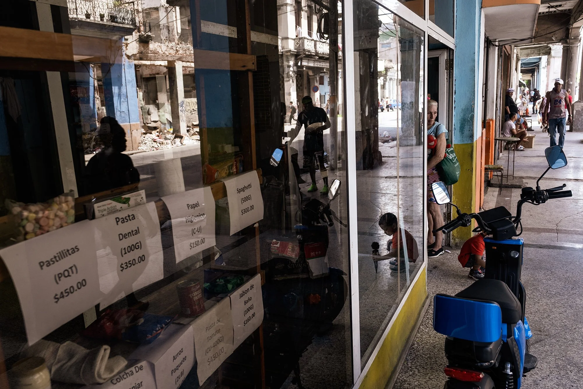 A shop window in Havana displays the few items still available — including some medicines, food products, soap, and other basic goods. 