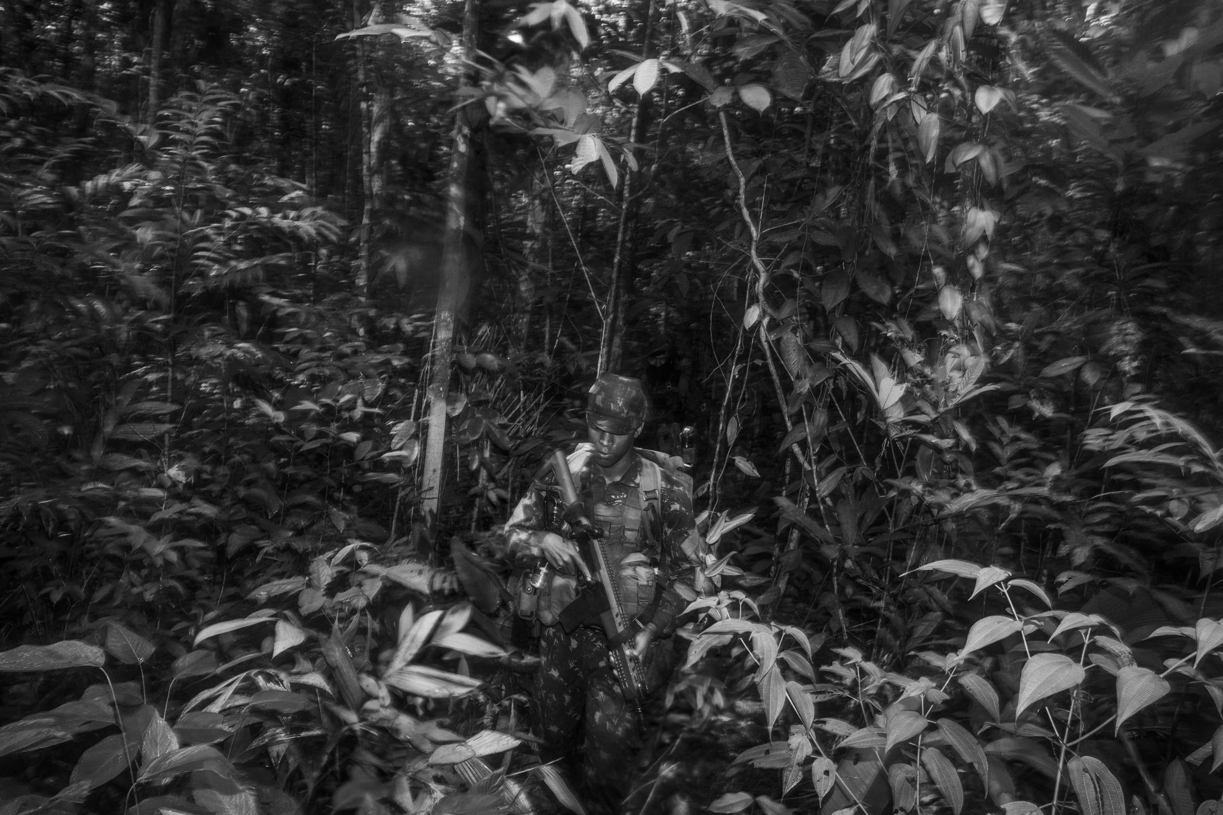 Members of the Brazilian Army’s special forces unit Selva patrol a jungle trail along the Brazilian/Colombian border.
