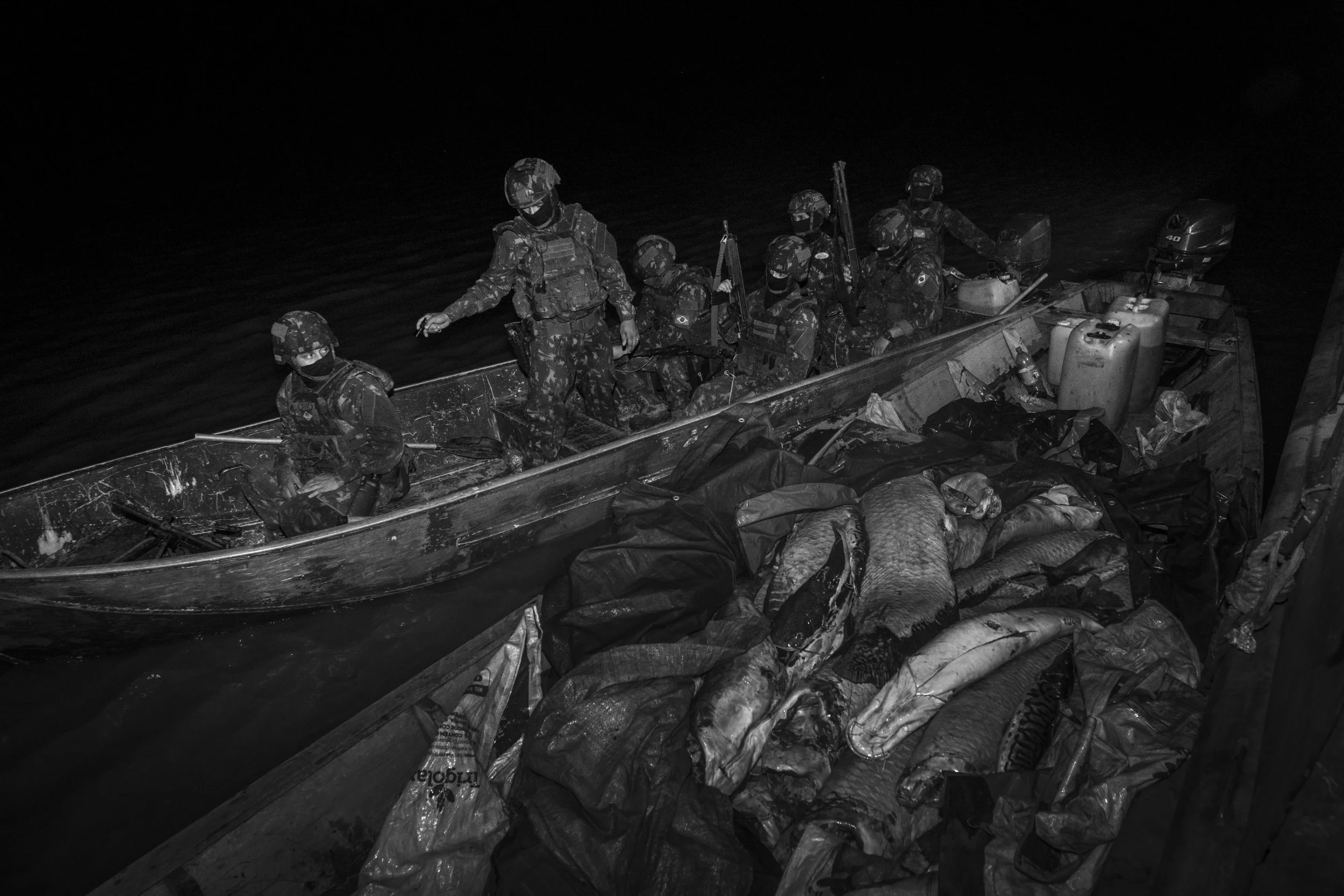 Brazilian Army soldiers intercept a boat carrying two fishermen navigating at night along the Solimões River, near the community of Capacete, and seize a cargo of illegally caught Amazonian fish, including the valuable pirarucu. Illegal fishing is wi