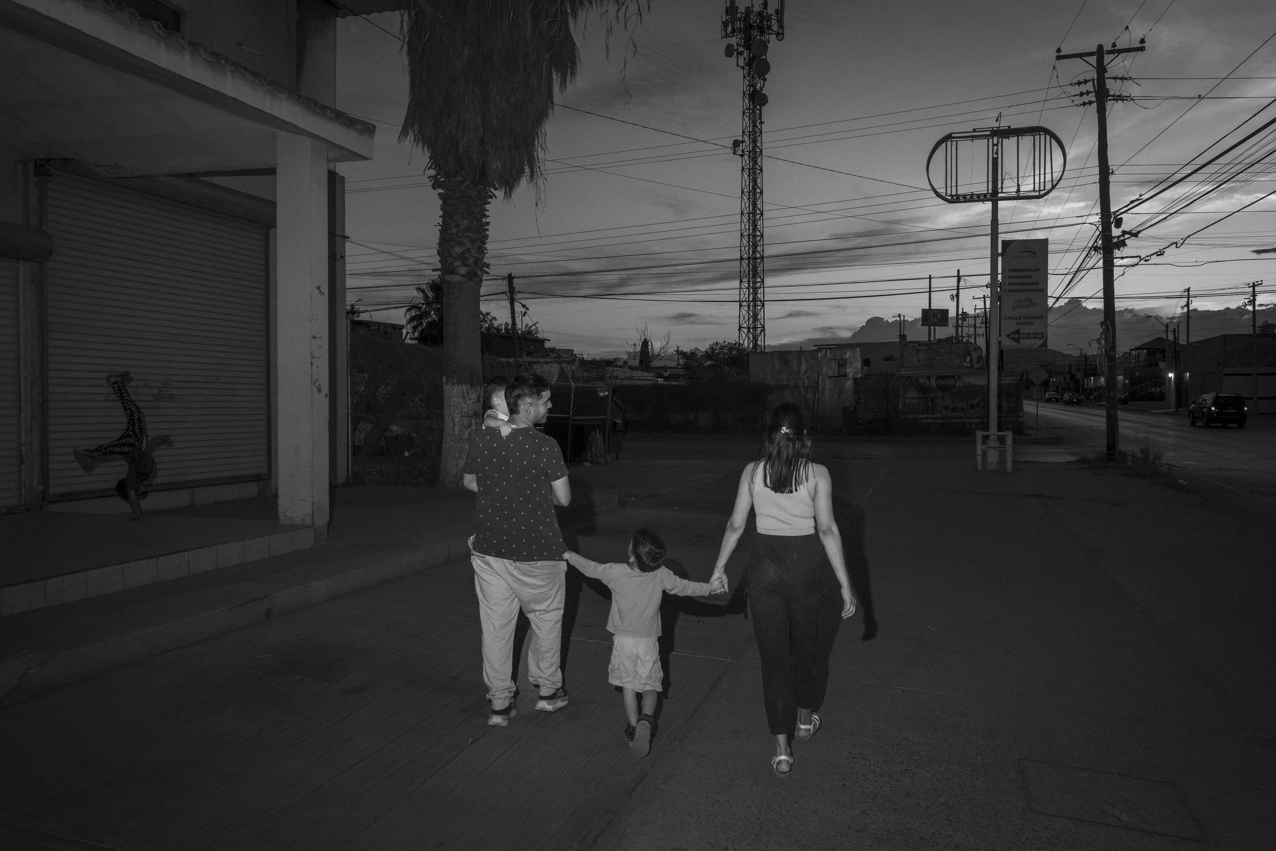 Cesar Atencio and Lina Isabel Arias, along with their sons Angel and Simon, return to a migrant shelter in Ciudad Juarez after a visit to a nearby playground.