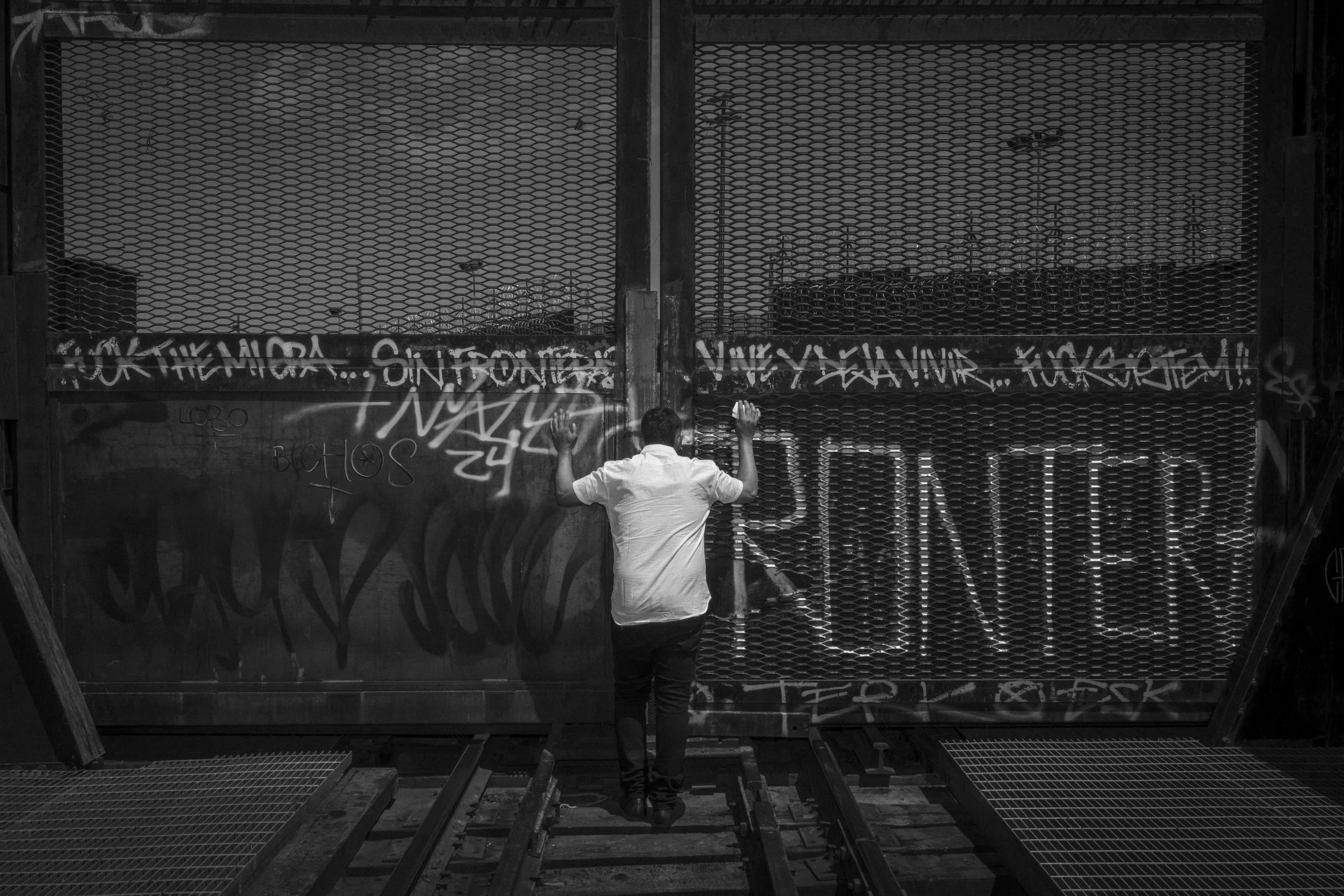  Cesar Atencio looks through the border fence dividing Ciudad Juarez from El Paso.